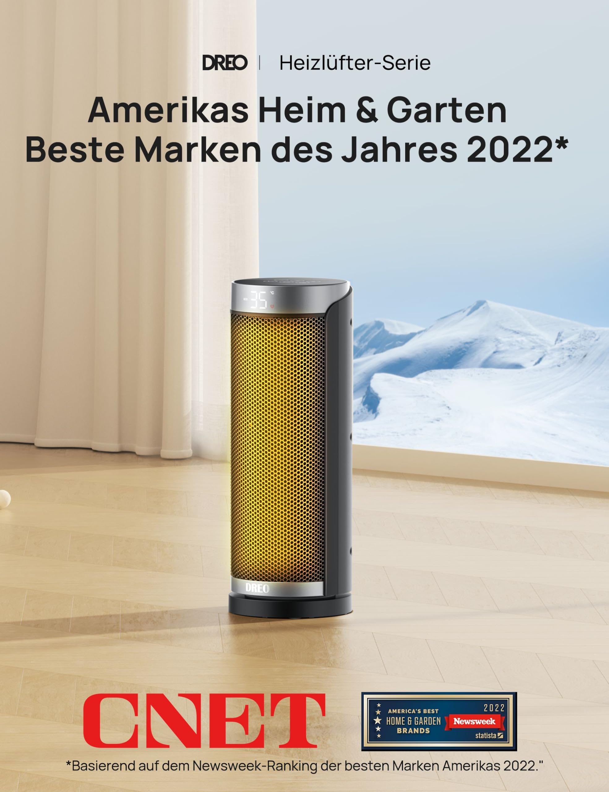 Ein beleuchteter schwarzer und goldener Dreo Heizlüfter steht auf einem Holzfußboden vor einem schneebedeckten Berg.