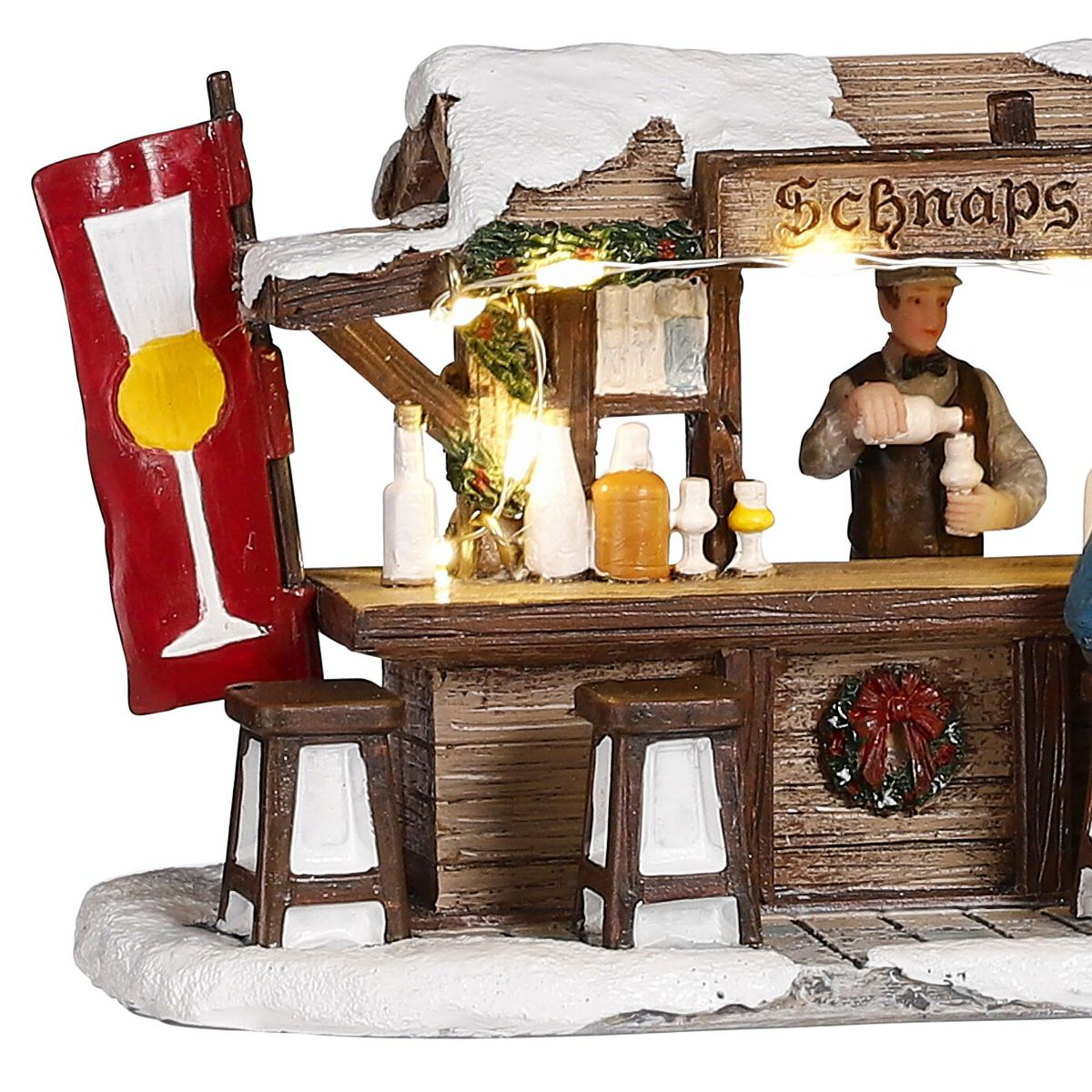 Stand de schnaps miniature enneigé avec barman, tabourets, guirlande lumineuse et bannière rouge.