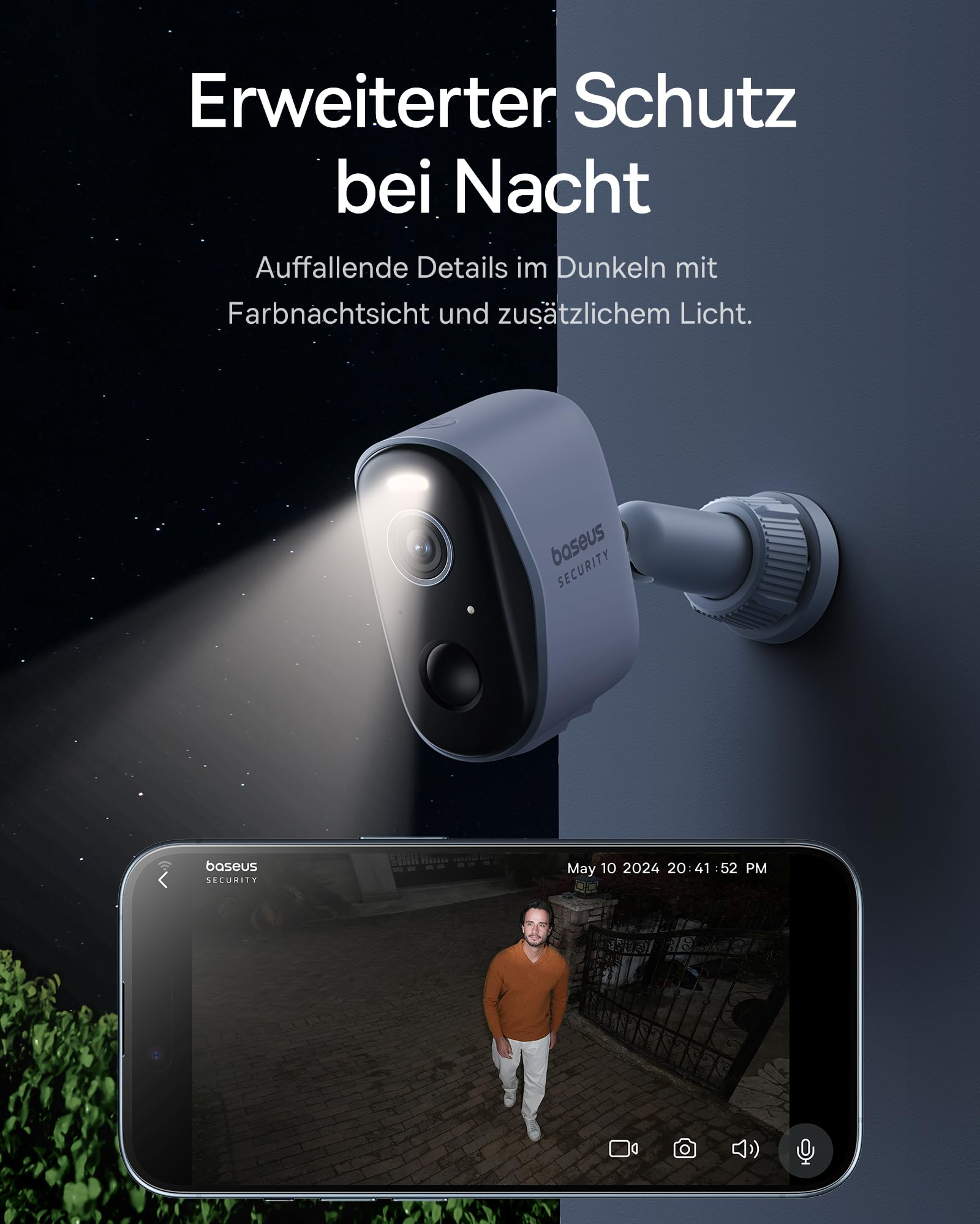 Una telecamera di sicurezza Baseus grigia illumina la notte, mostrando un uomo su uno smartphone.
