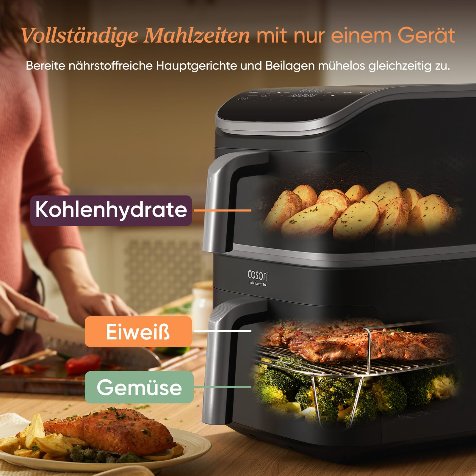 Une friteuse à air noire cuit des quartiers de pommes de terre en haut et du steak avec du brocoli en bas.