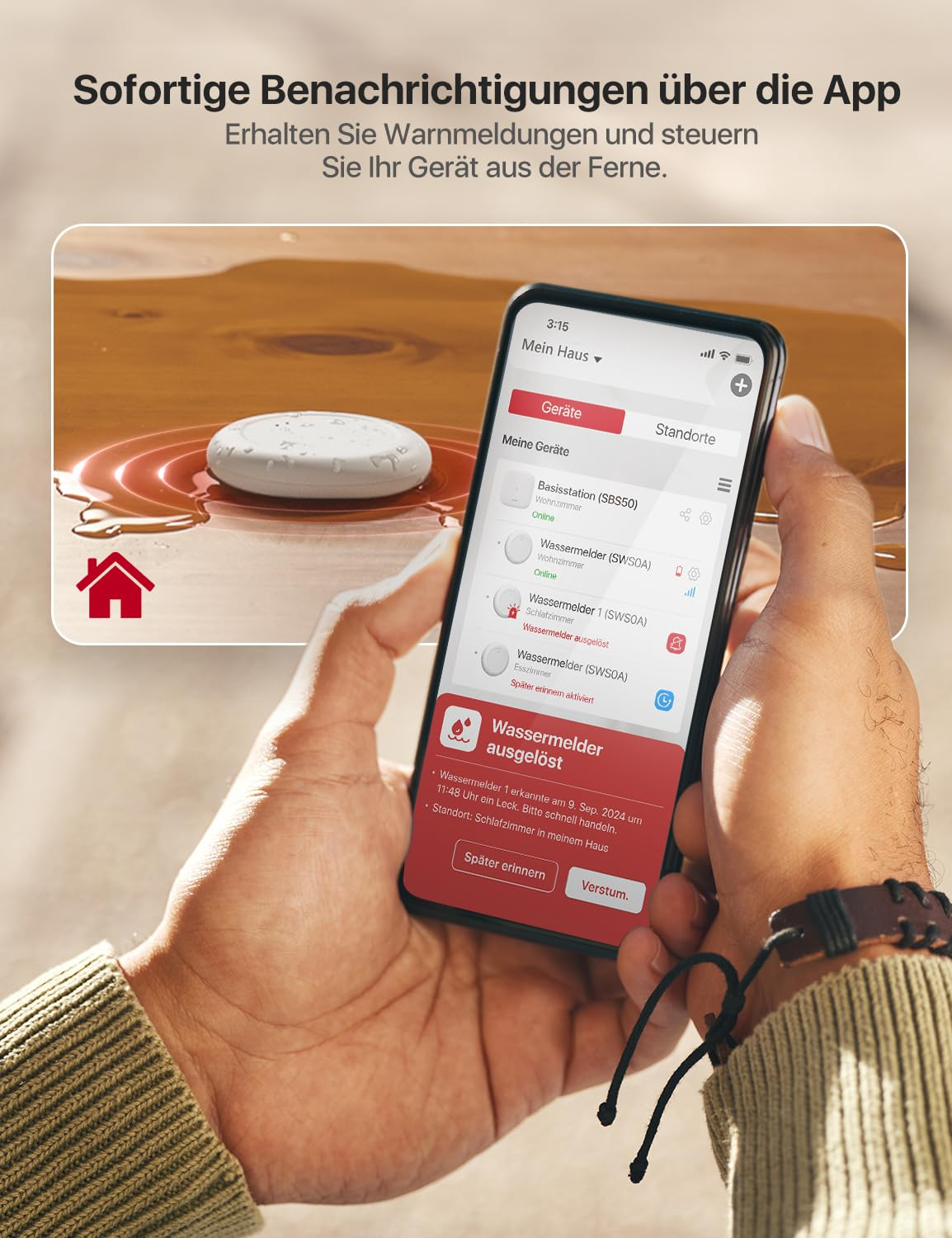 Smartphone mostra un'app di allarme acqua, con un rilevatore d'acqua bianco in una pozzanghera.