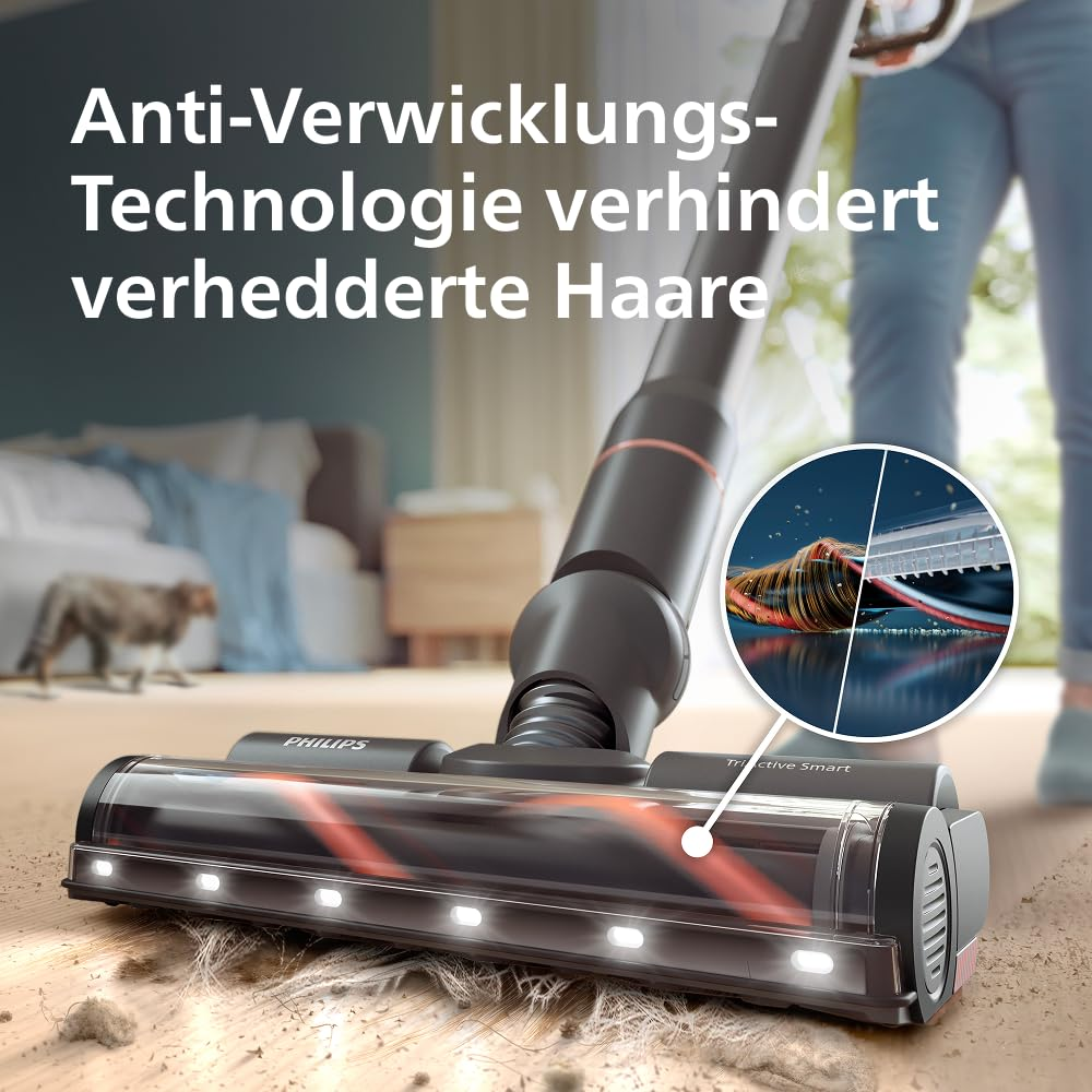 Philips Staubsaugerkopf mit LED-Beleuchtung auf einem Holzboden mit Haaren und Verhedderungsschutz.
