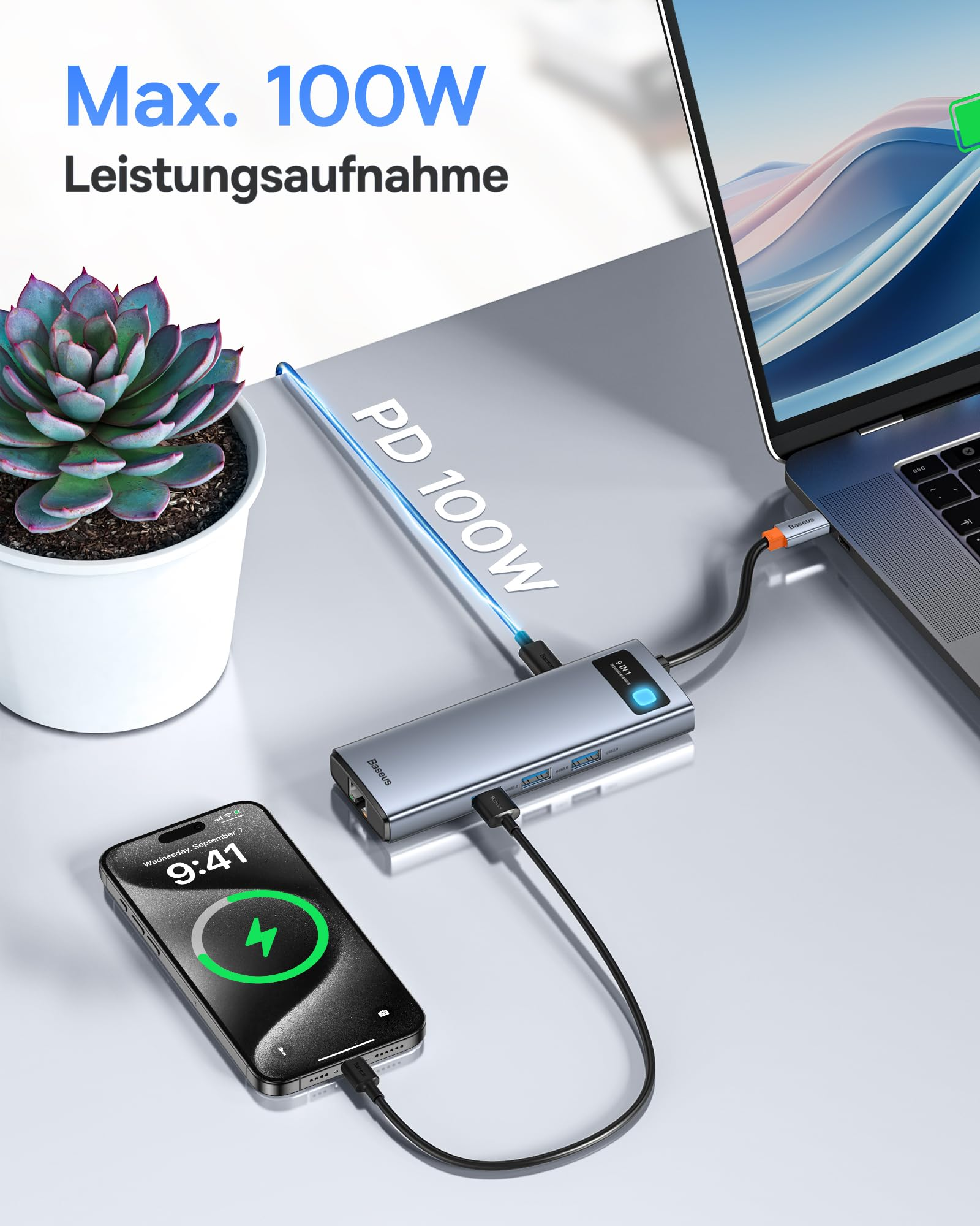 Un hub USB-C collega un laptop e un telefono in carica su una scrivania.