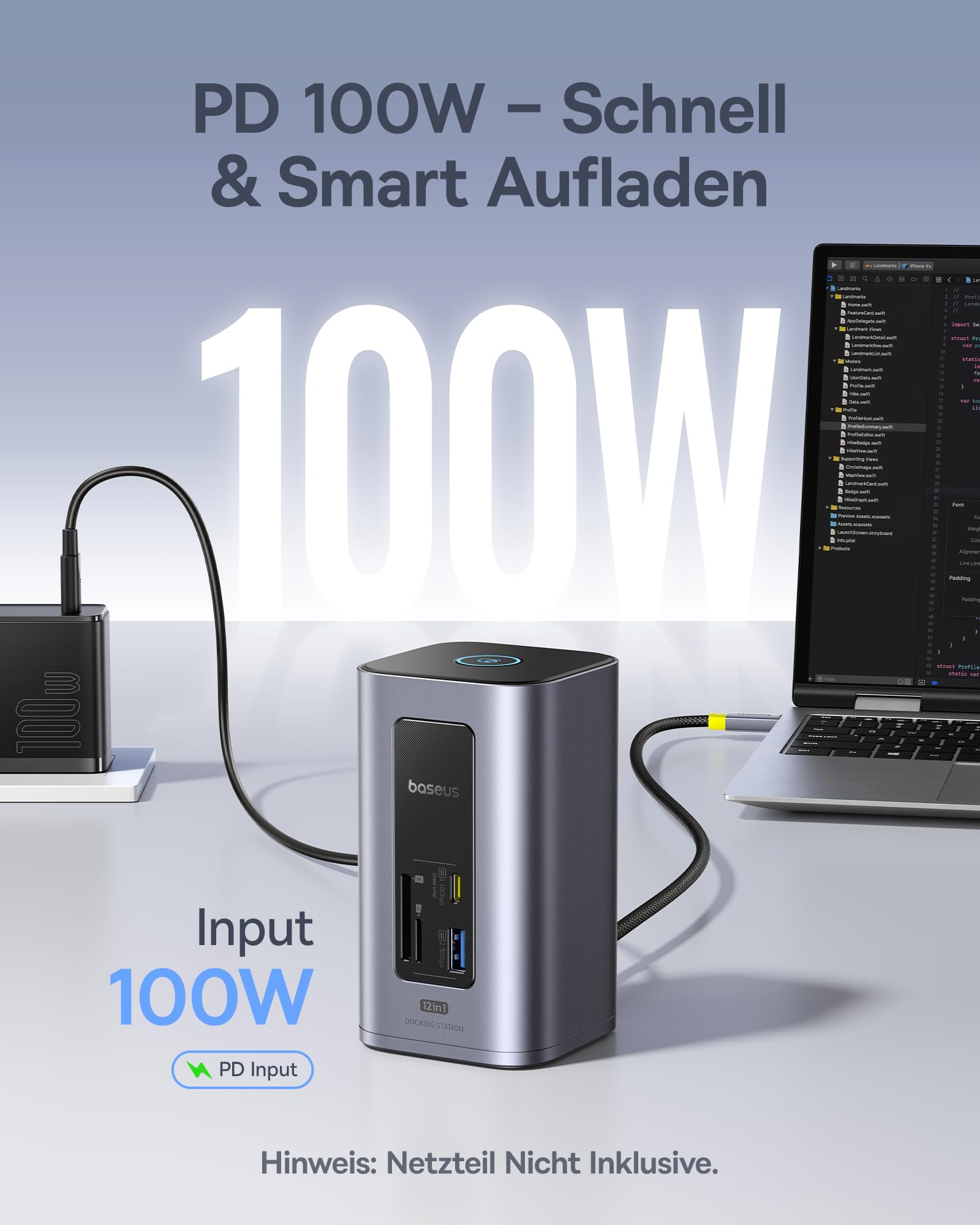 Eine graue Baseus 12in1 Dockingstation steht auf einem Tisch mit Laptop und Netzteil.