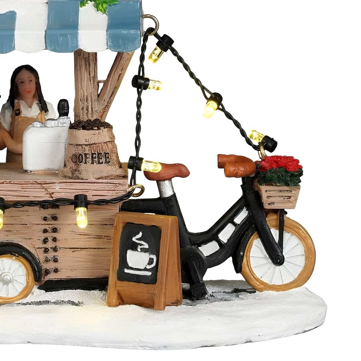 Model van een koffiekraam met barista, bord, sfeerlichtjes en fiets met bloemenmand.