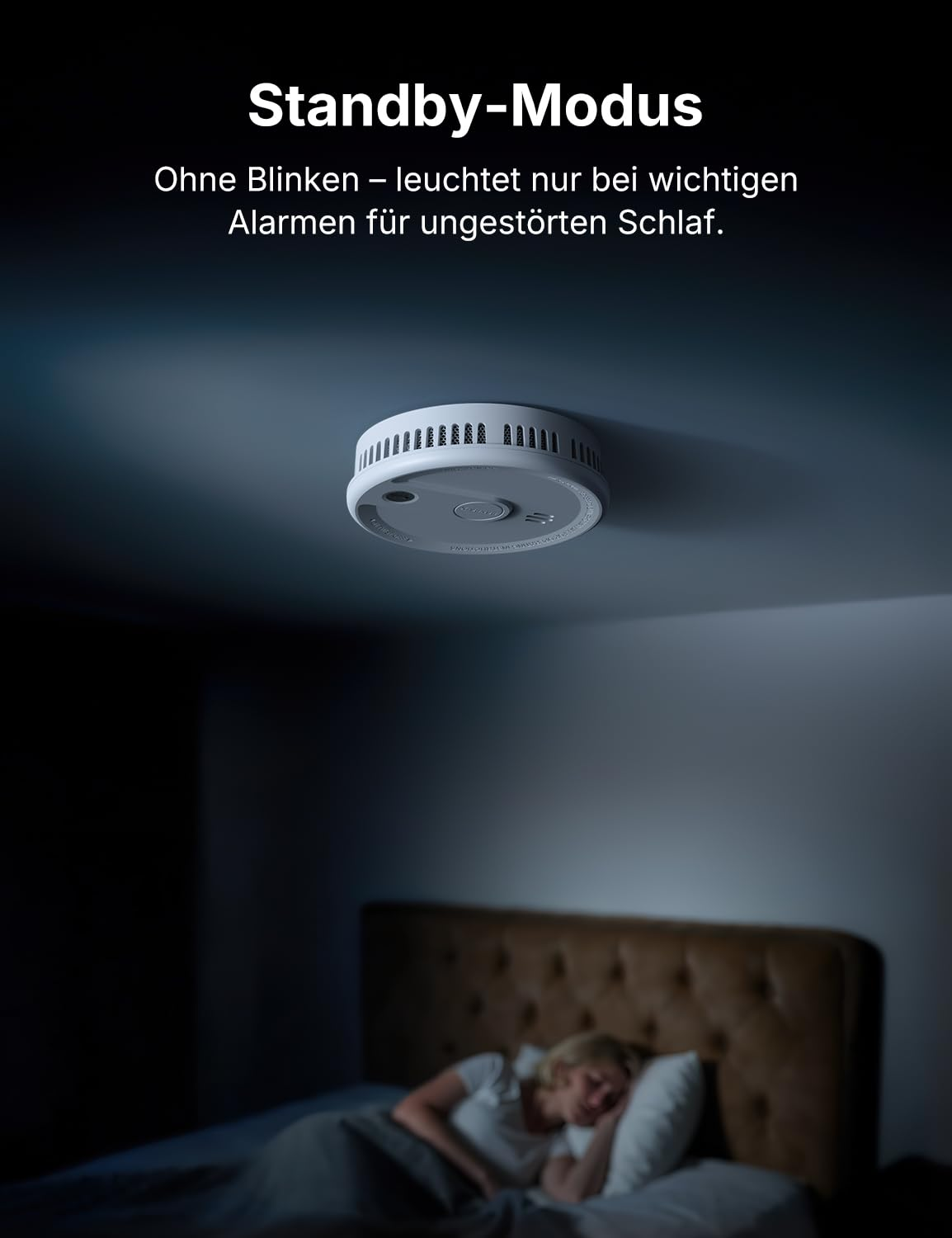 Ein rauchmelder an der decke eines dunklen schlafzimmers, während eine person im bett schläft.