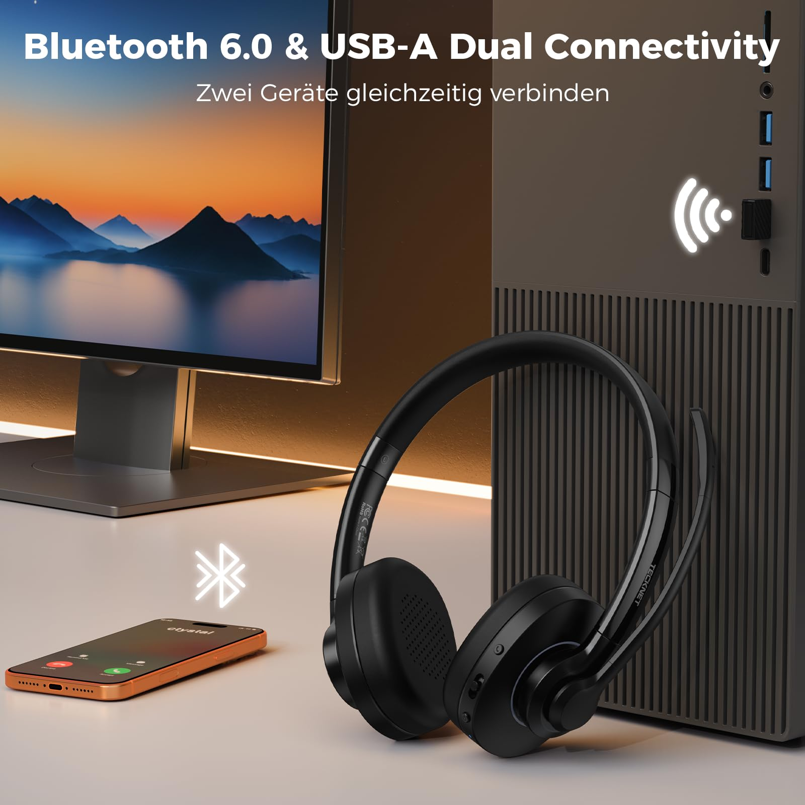 Schwarzes Wireless-Headset auf Schreibtisch mit Smartphone und PC, zeigt Bluetooth 6.0 und USB-A Dual-Konnektivität.