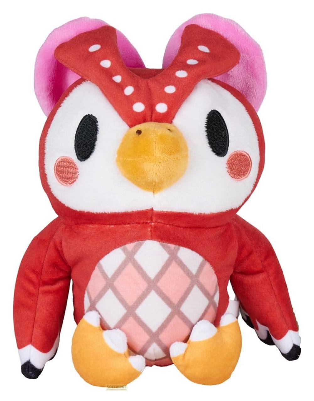 Ein rotes Stofftier mit großen Augen, weißen Punkten und rosa Ohren.