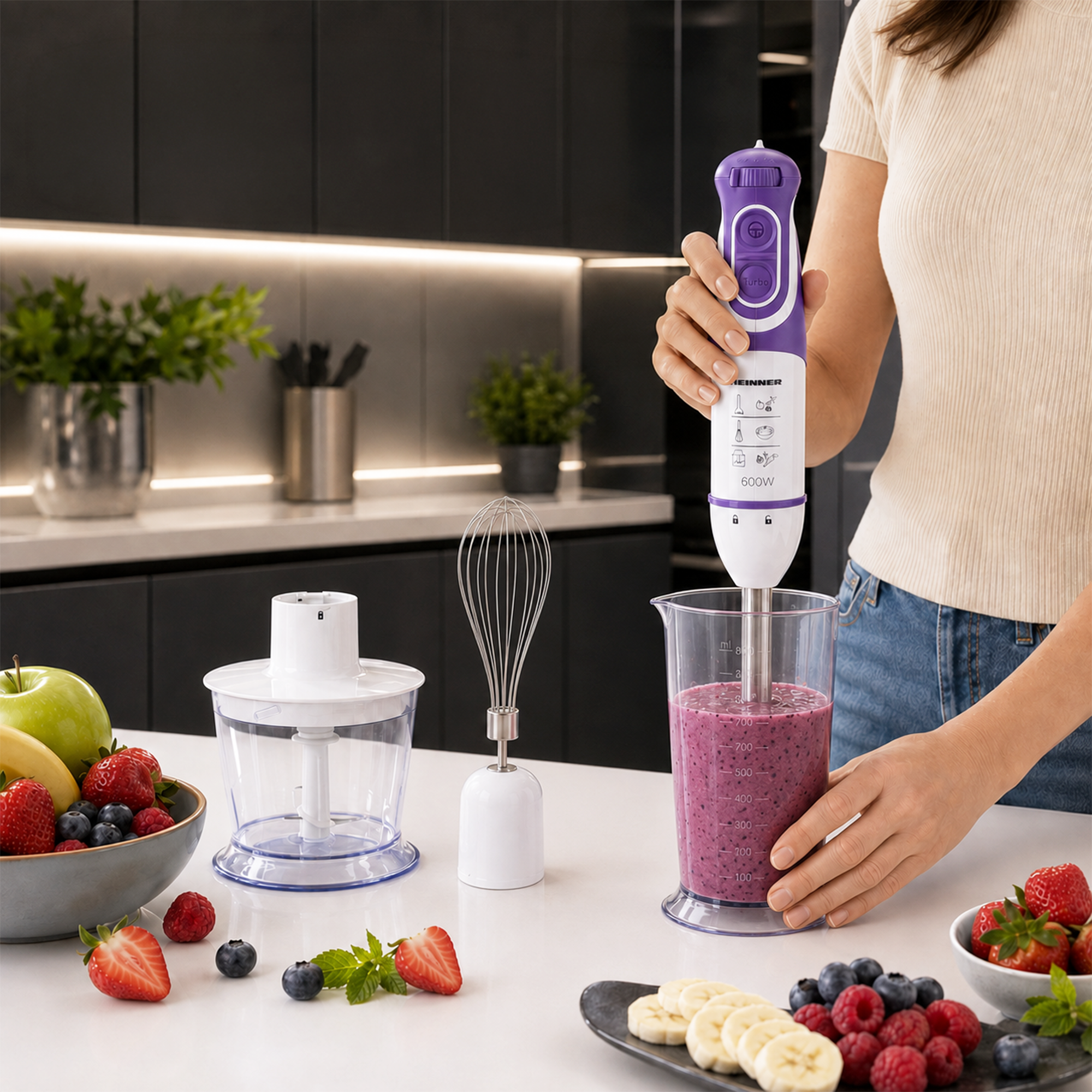 A woman uses a purple and white hand blender to mix a berry smoothie in a kitchen.