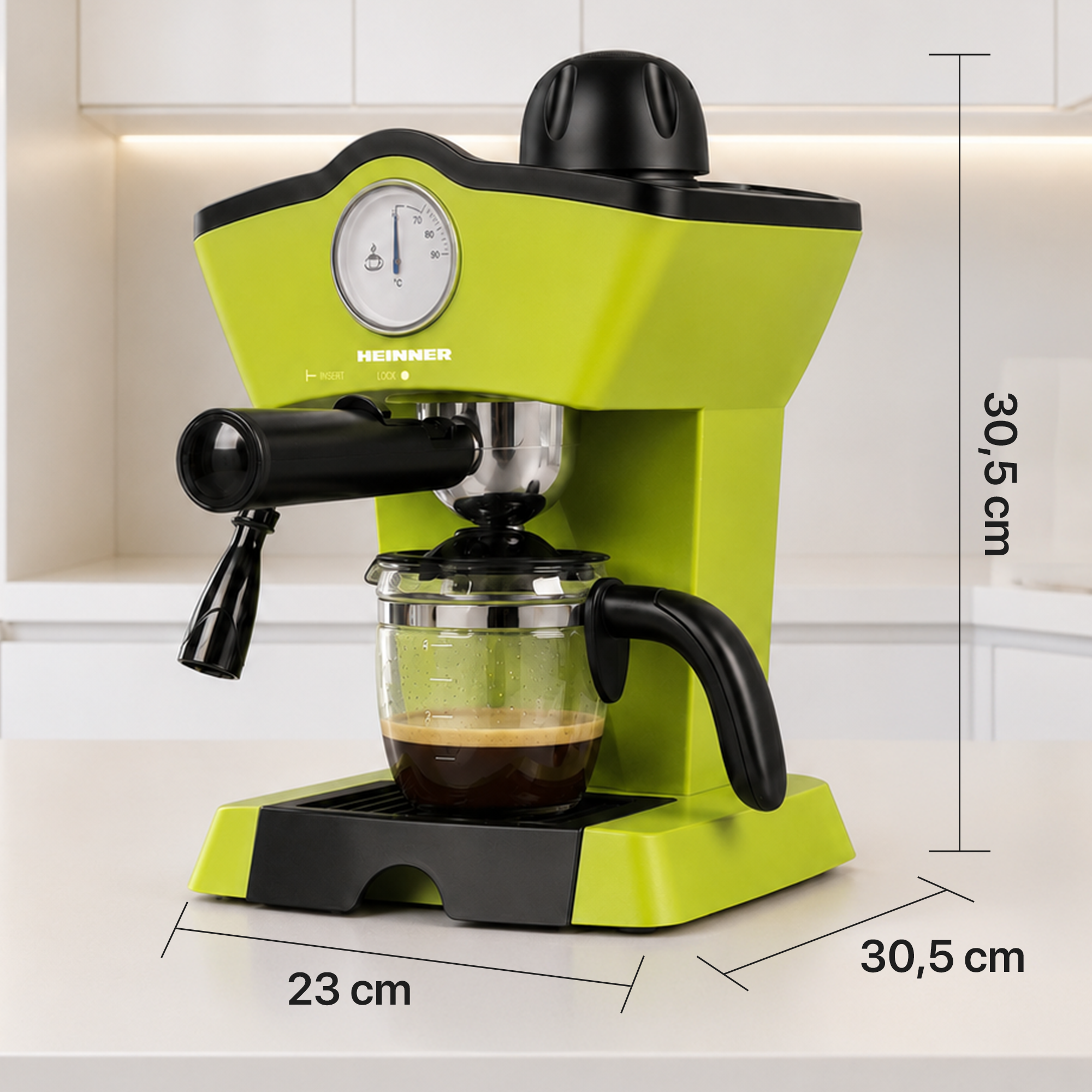 A lime green espresso machine with a glass carafe on a white counter, featuring dimensions of 30.5 cm by 23 cm.