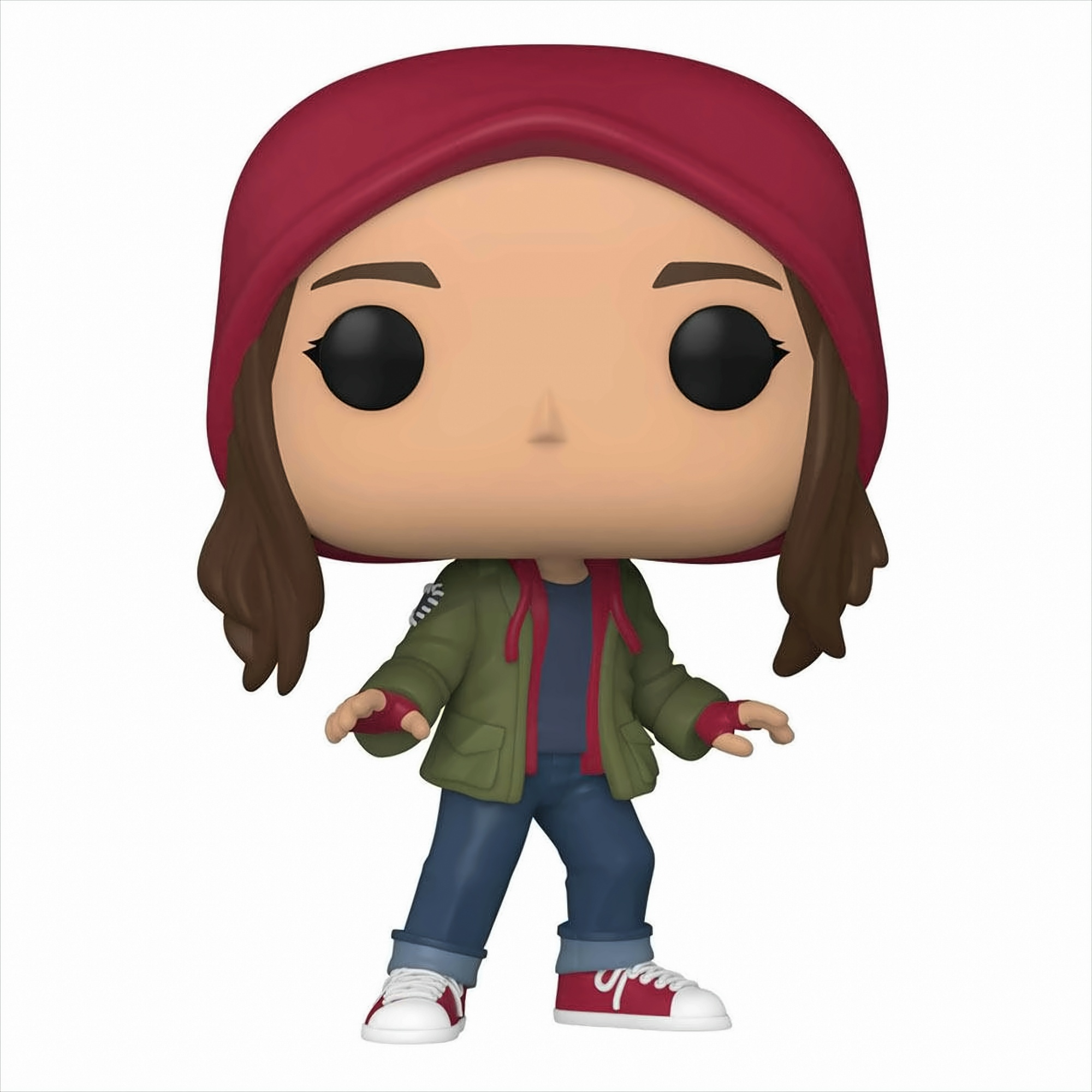 Una figura de vinilo de una chica con pelo castaño, gorro rojo, chaqueta verde, vaqueros azules y zapatillas rojas y blancas.