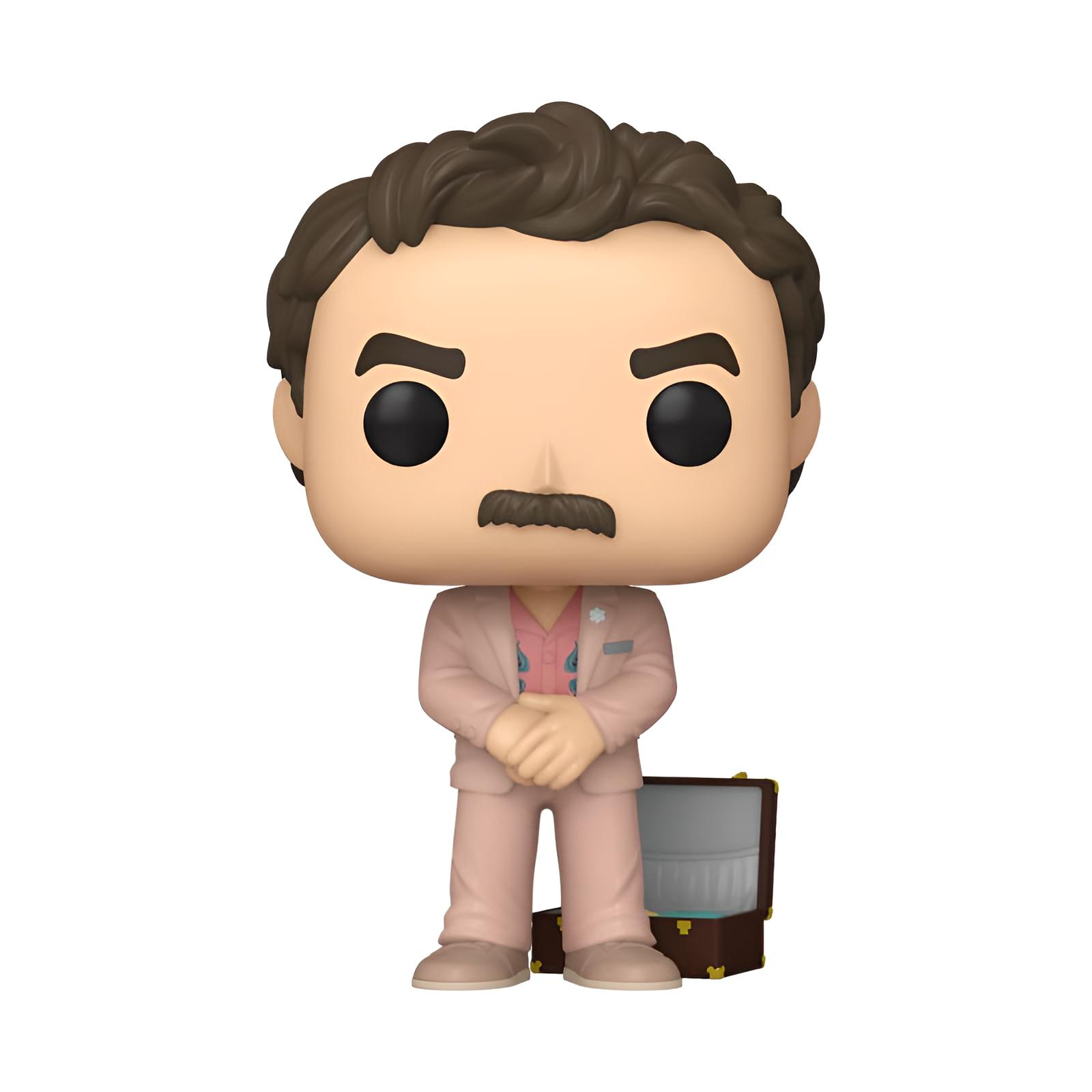 Una figura Funko Pop con pelo castaño y bigote, vestido con traje rosa, está junto a una maleta pequeña.