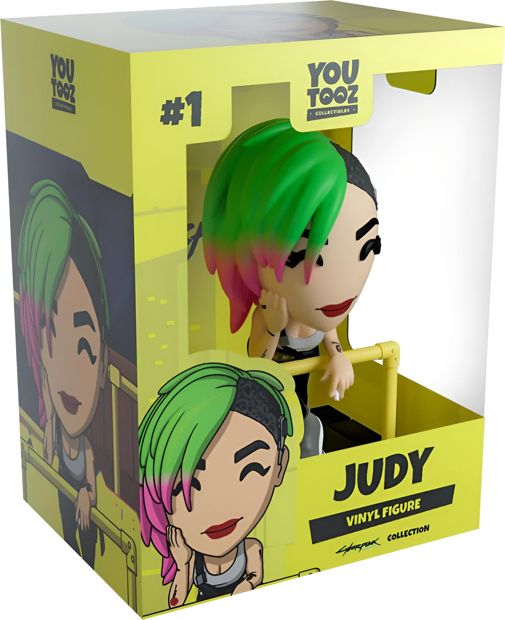 Una caja de figura de vinilo Youtooz amarilla que muestra a Judy de Cyberpunk 2077 con cabello verde y rosa.