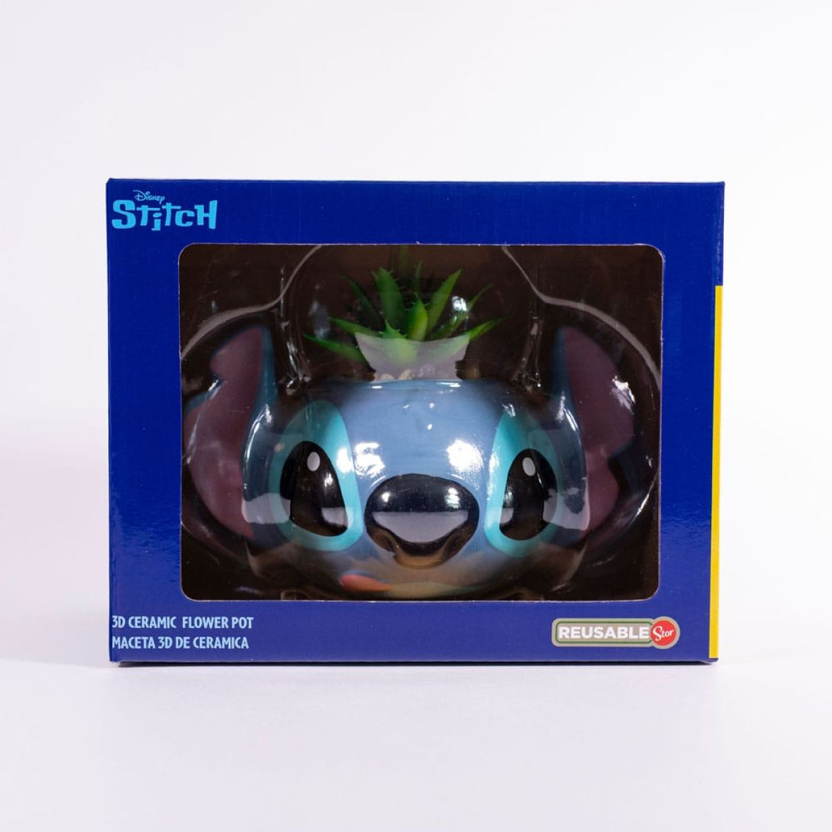 Maceta de cerámica 3D de Disney Stitch azul en su caja original con una pequeña planta artificial.