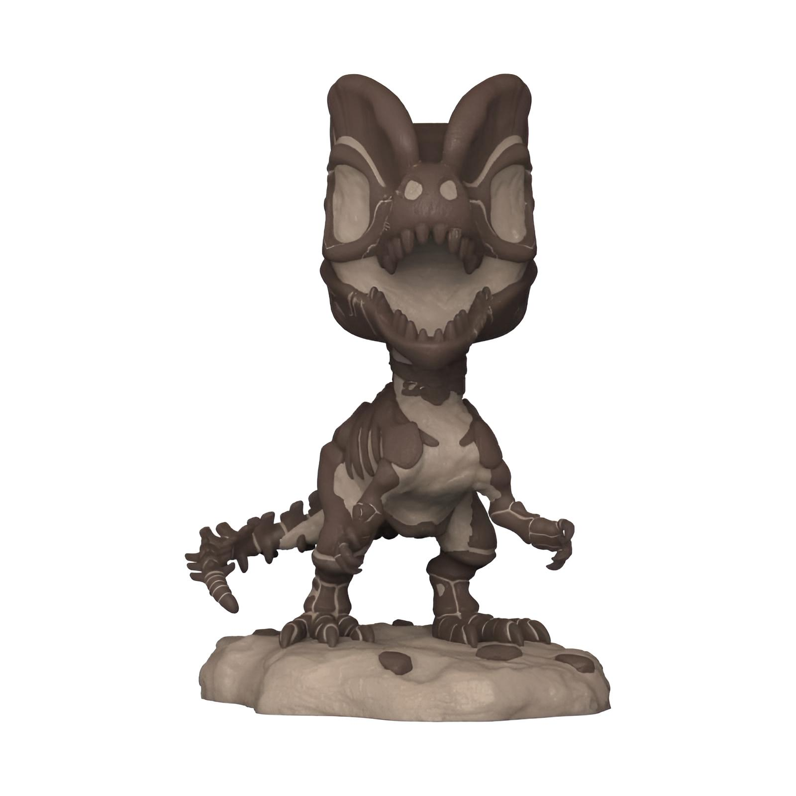 Una figura de vinilo de esqueleto de dinosaurio marrón con cabeza grande y boca abierta sobre una base rocosa.