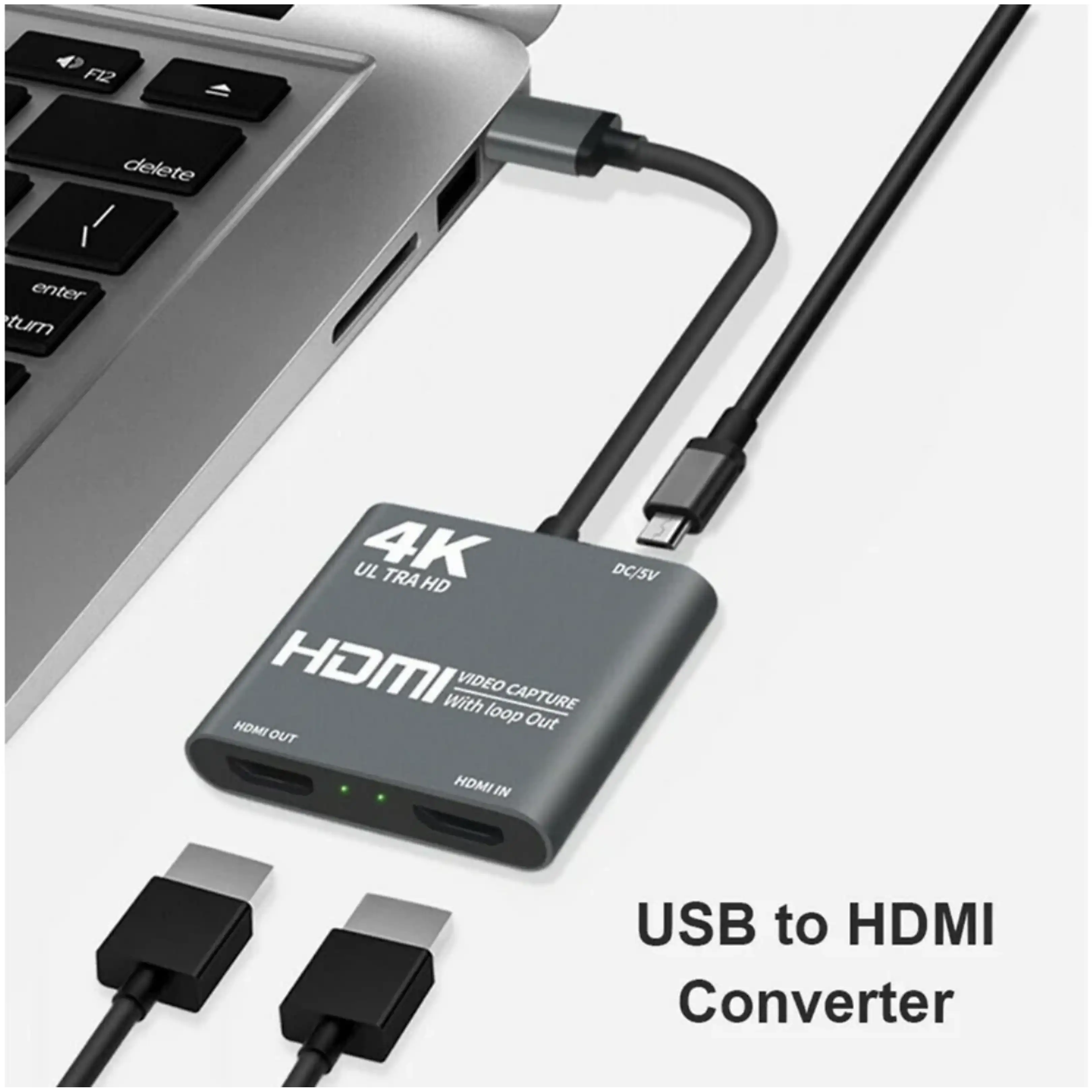 Grauer 4K Ultra HD HDMI Video Capture Adapter angeschlossen an Laptop mit USB-Kabel.