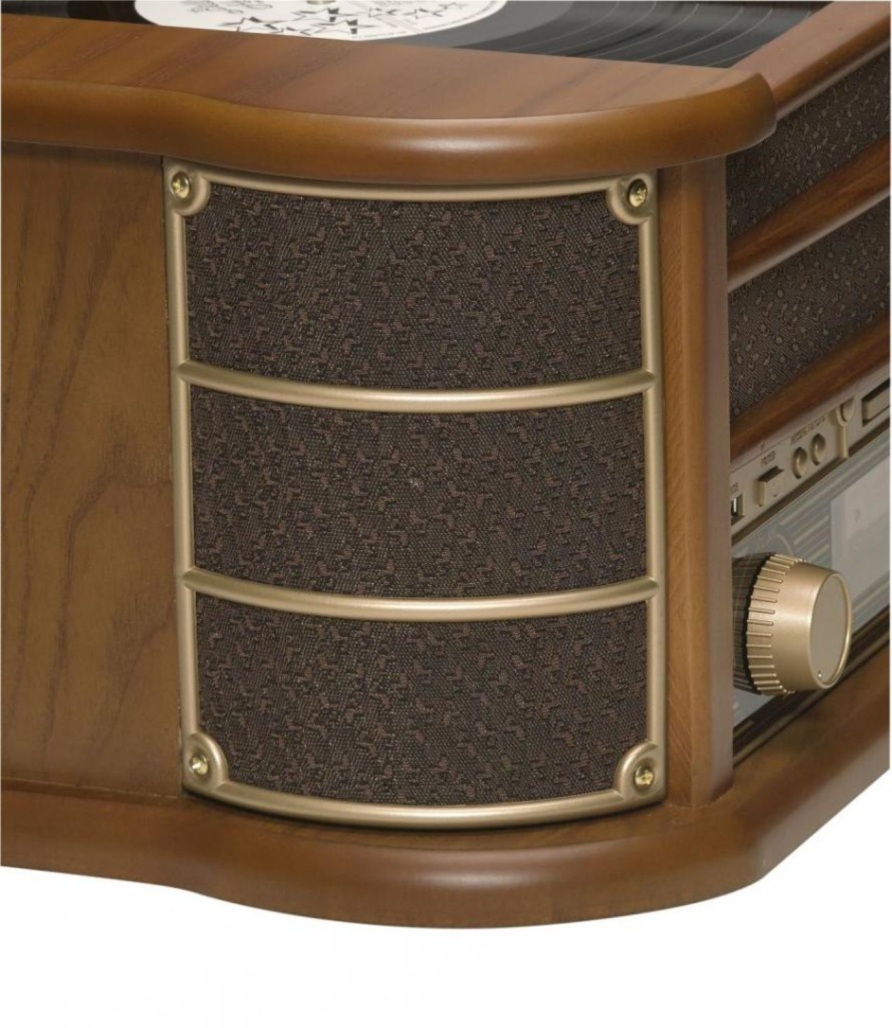 Close-up of a wooden music center featuring a textured speaker grille and a gold volume knob.