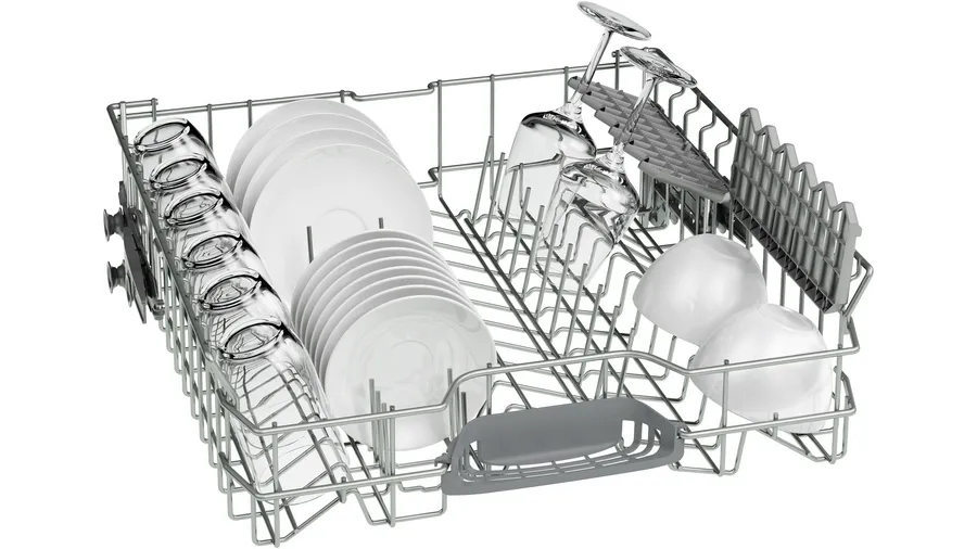 An upper dishwasher rack filled with glasses, plates, and bowls.