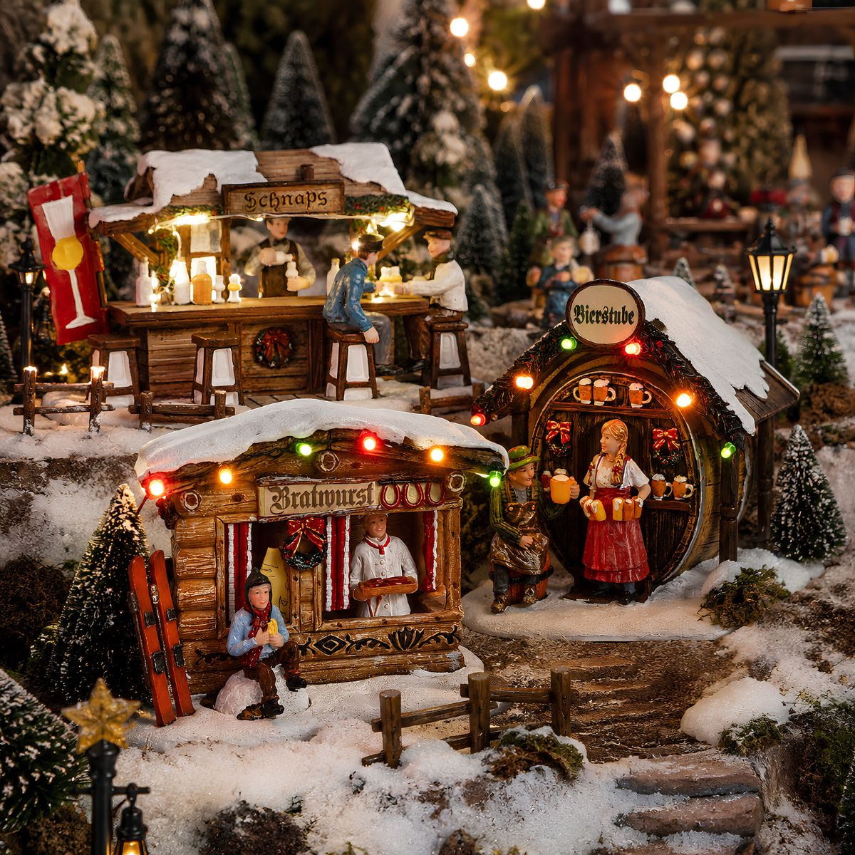 Miniature Christmas market with lit stalls, bratwurst stand, beer tavern, and figures in snow.