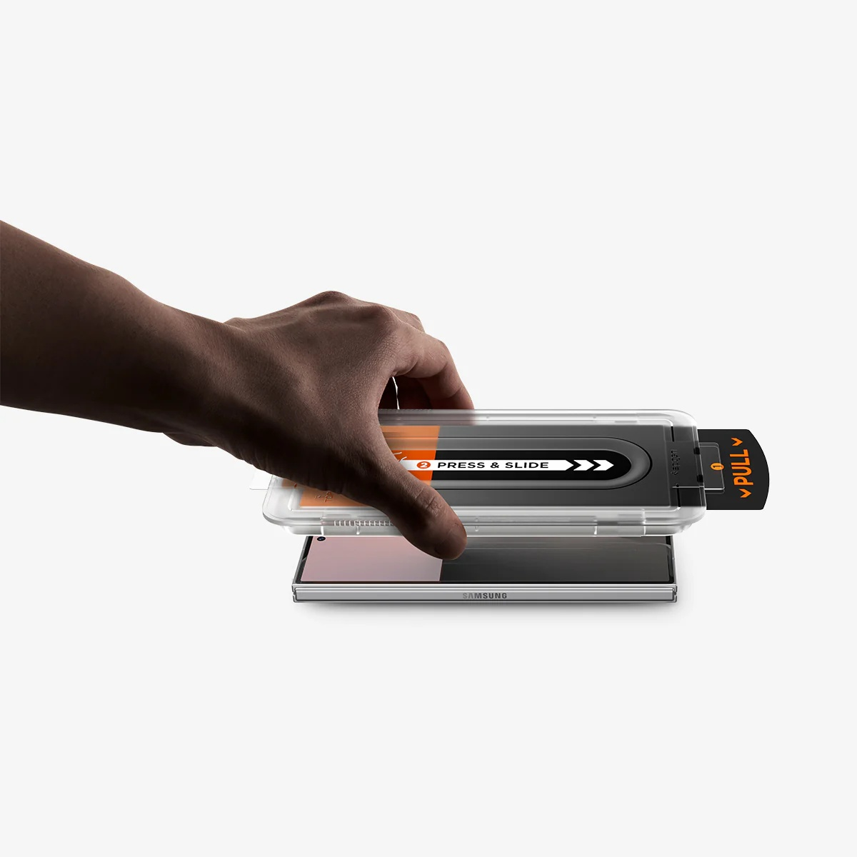 A hand places a clear installation guide with text over a Samsung smartphone.