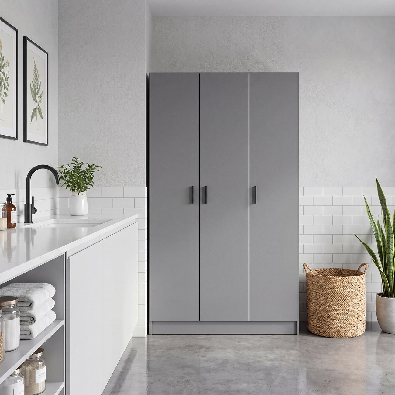 Habitación moderna con armario gris, encimera blanca, fregadero, plantas y cesta tejida.