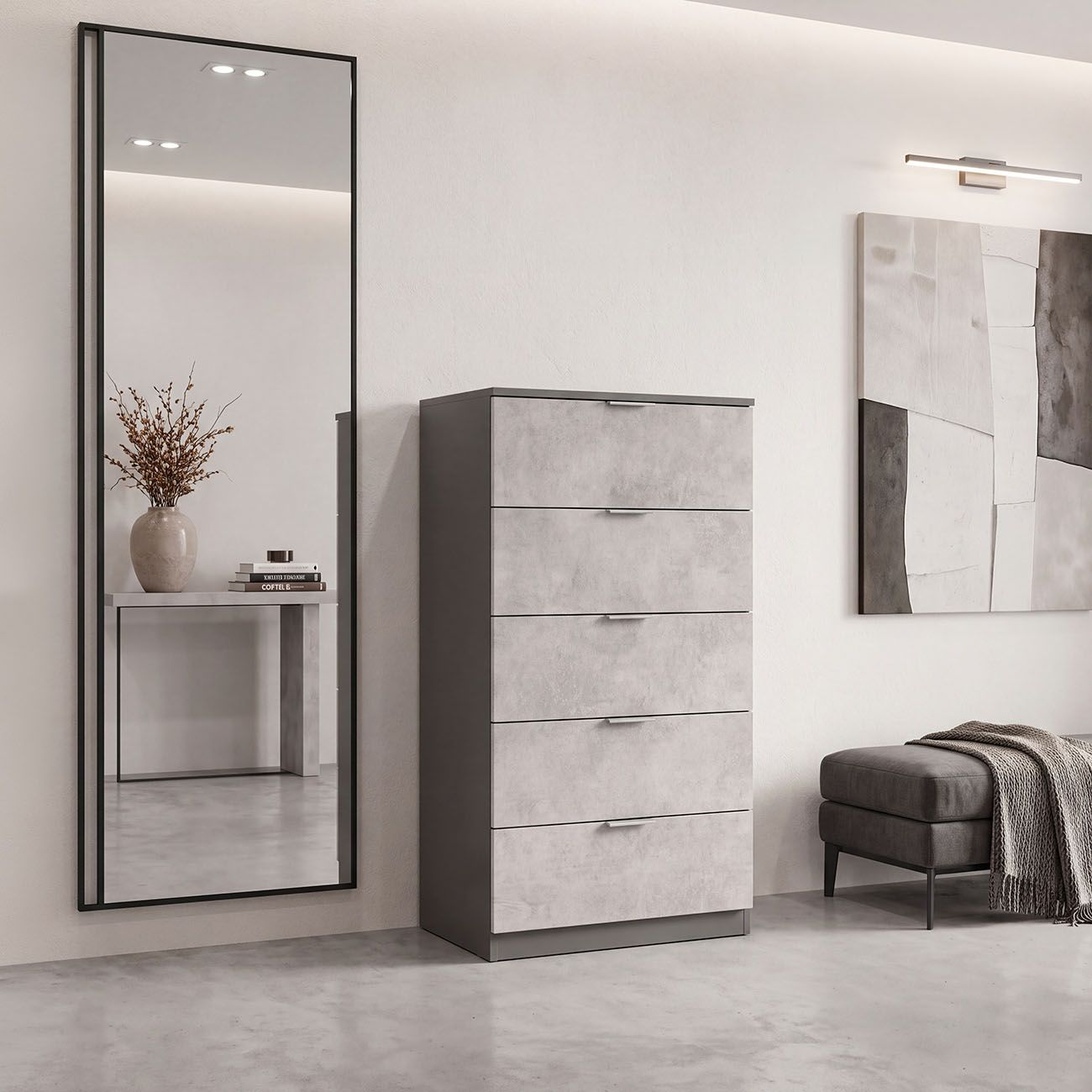 Una moderna cómoda gris se encuentra contra una pared blanca junto a un espejo alto y un banco.
