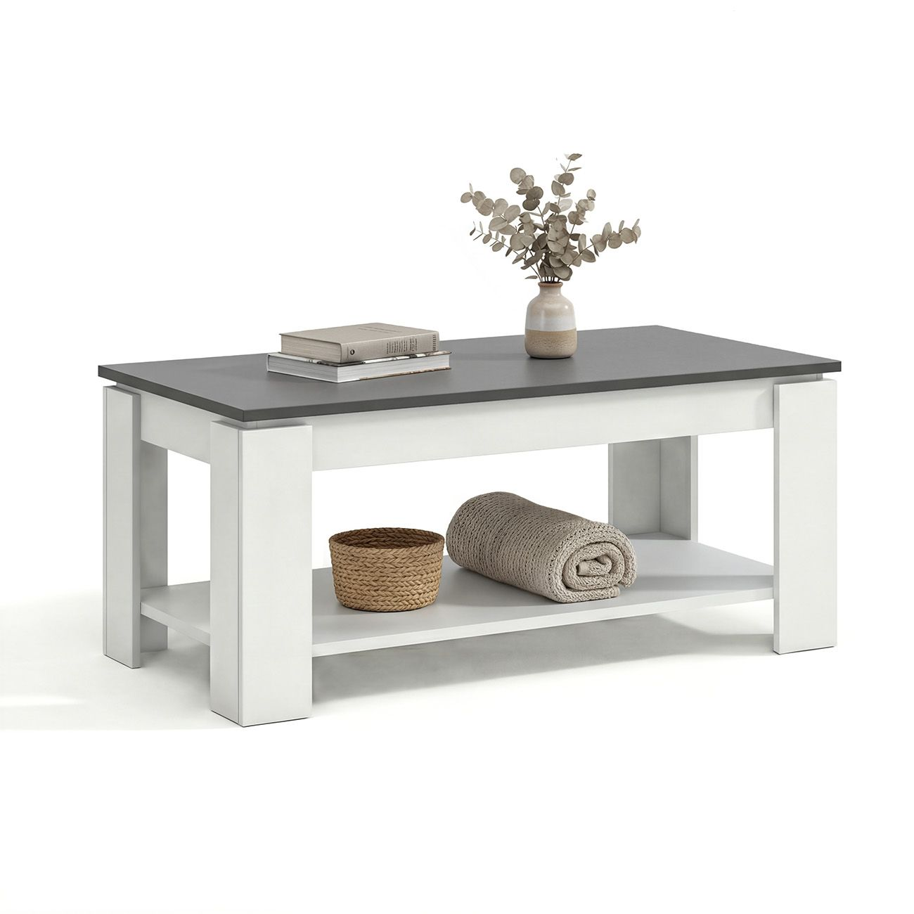 Mesa de centro blanca y gris oscura con estante inferior con libros, cesta y manta, coronada con un jarrón.