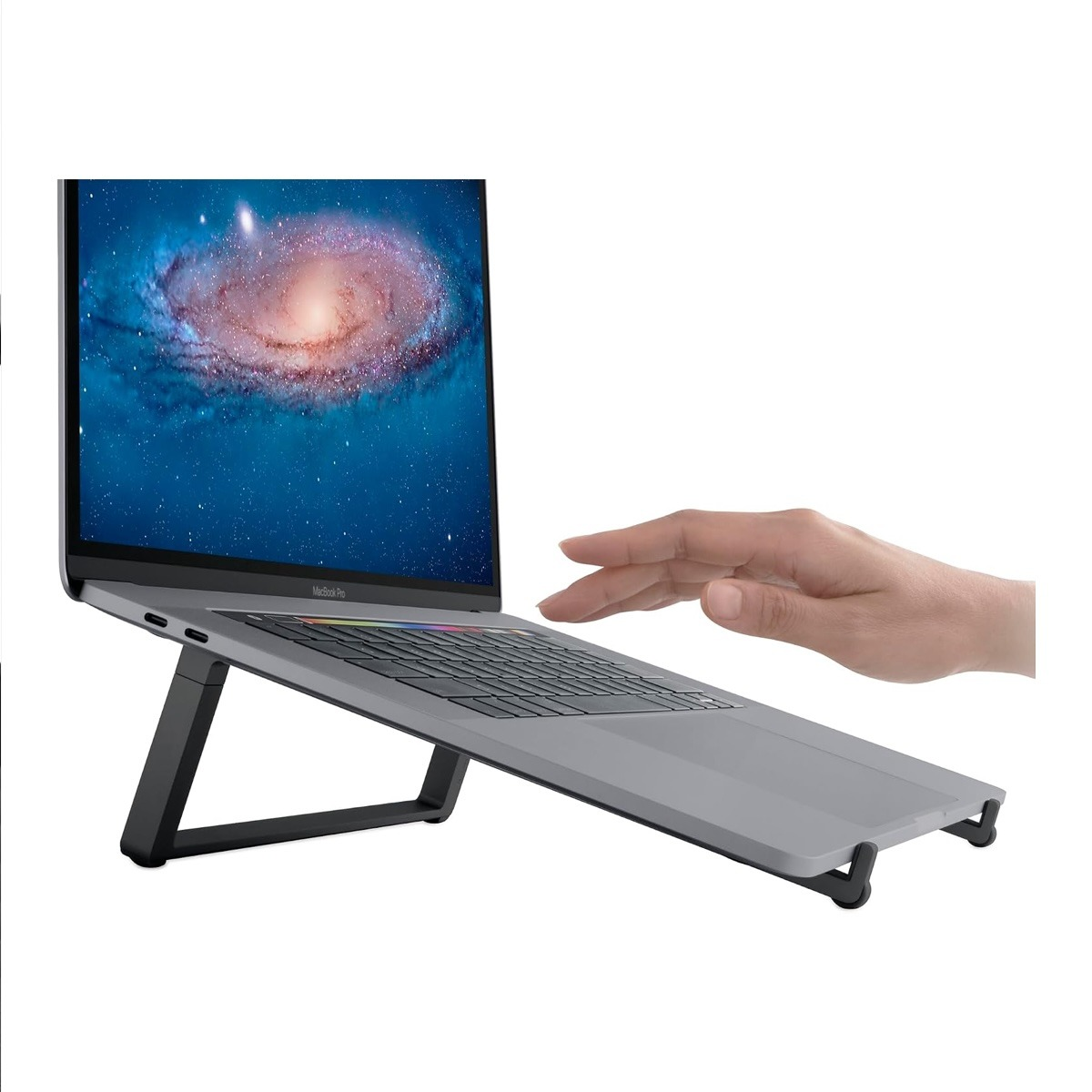 Ein silberner Laptop auf einem schwarzen Ständer, mit einer Hand daneben vor weißem Hintergrund.