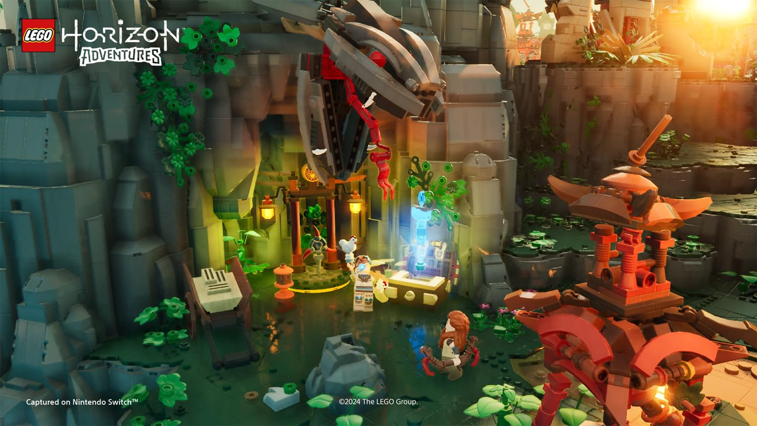 Escena de Lego Horizon Adventures con cueva, monstruo robot y minifiguras en un entorno verde.