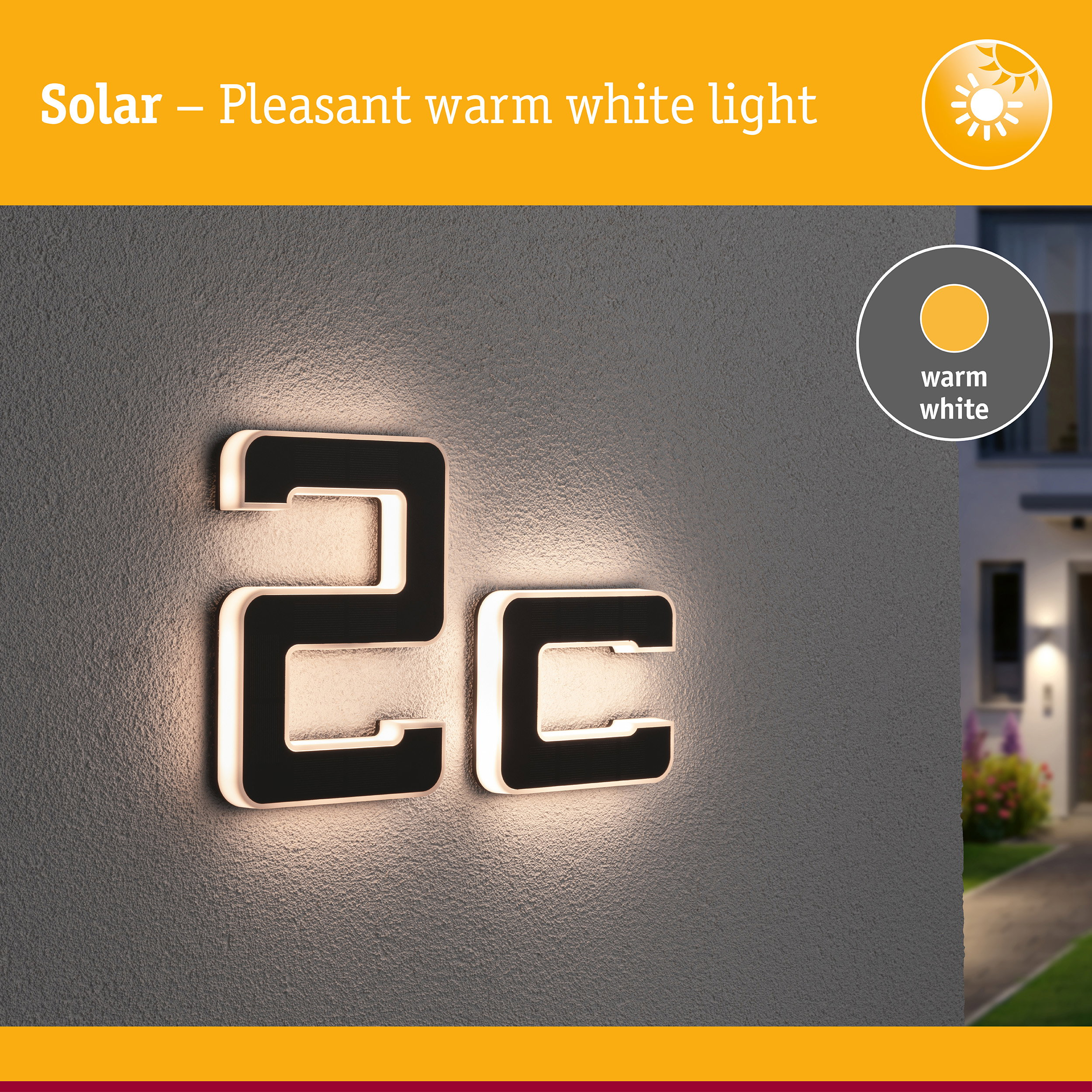 Beleuchtete Hausnummer 2c mit warmem weißem Licht an einer grauen Wand.