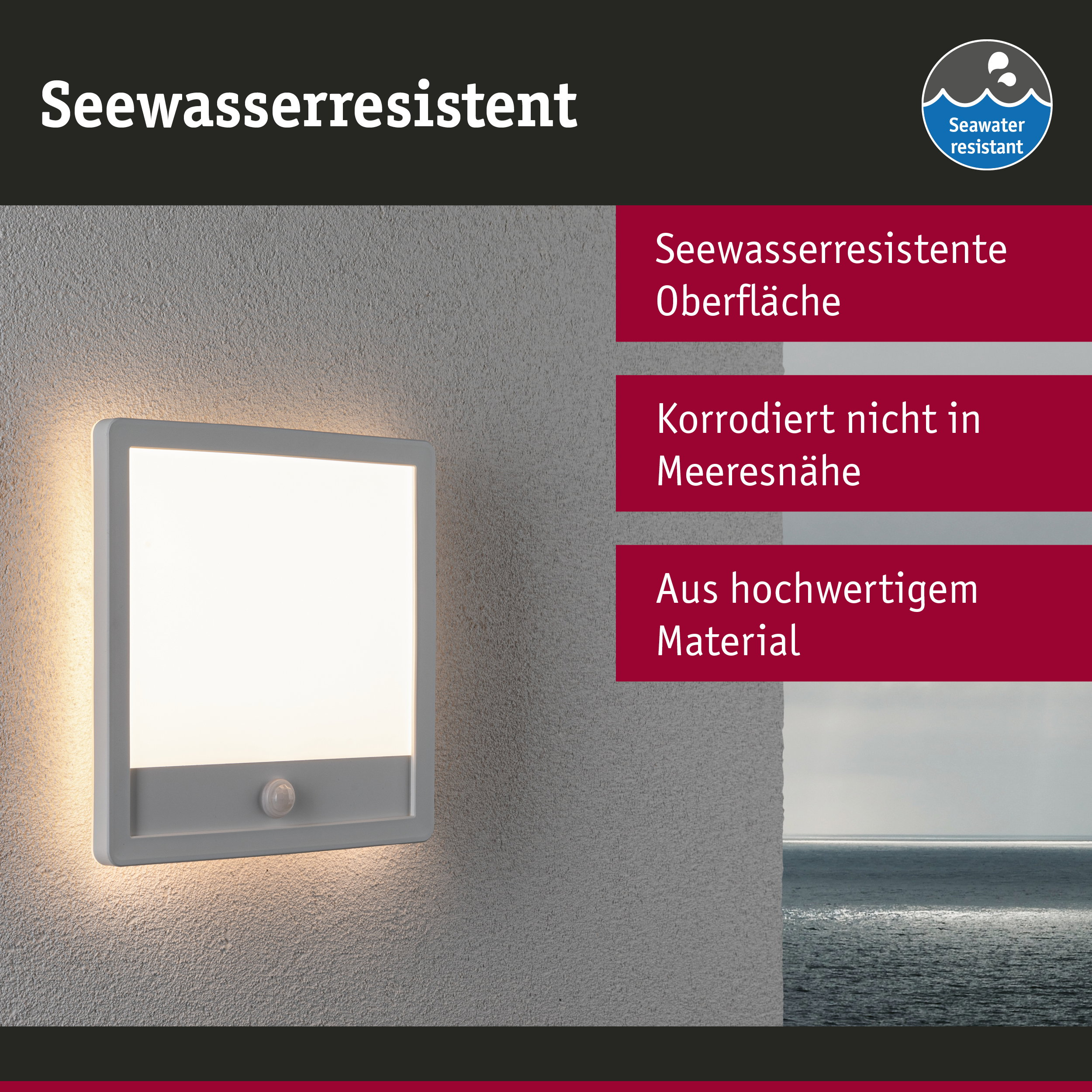 Biała lampa zewnętrzna z czujnikiem ruchu na szarej ścianie, z widokiem na morze w tle.