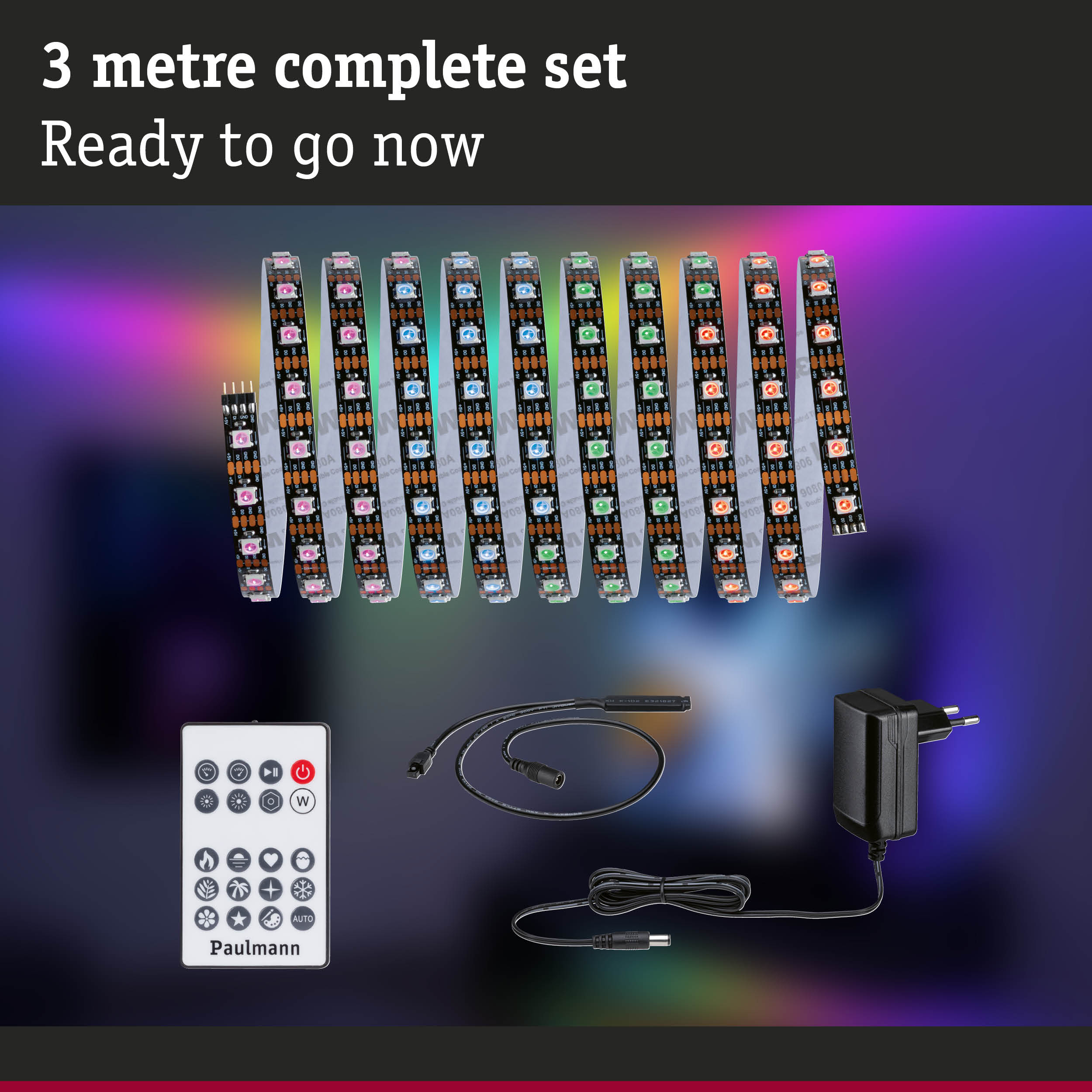 Ein 3 Meter Paulmann LED-Stripe-Set mit Fernbedienung, Netzteil und Kabeln vor buntem Hintergrund.