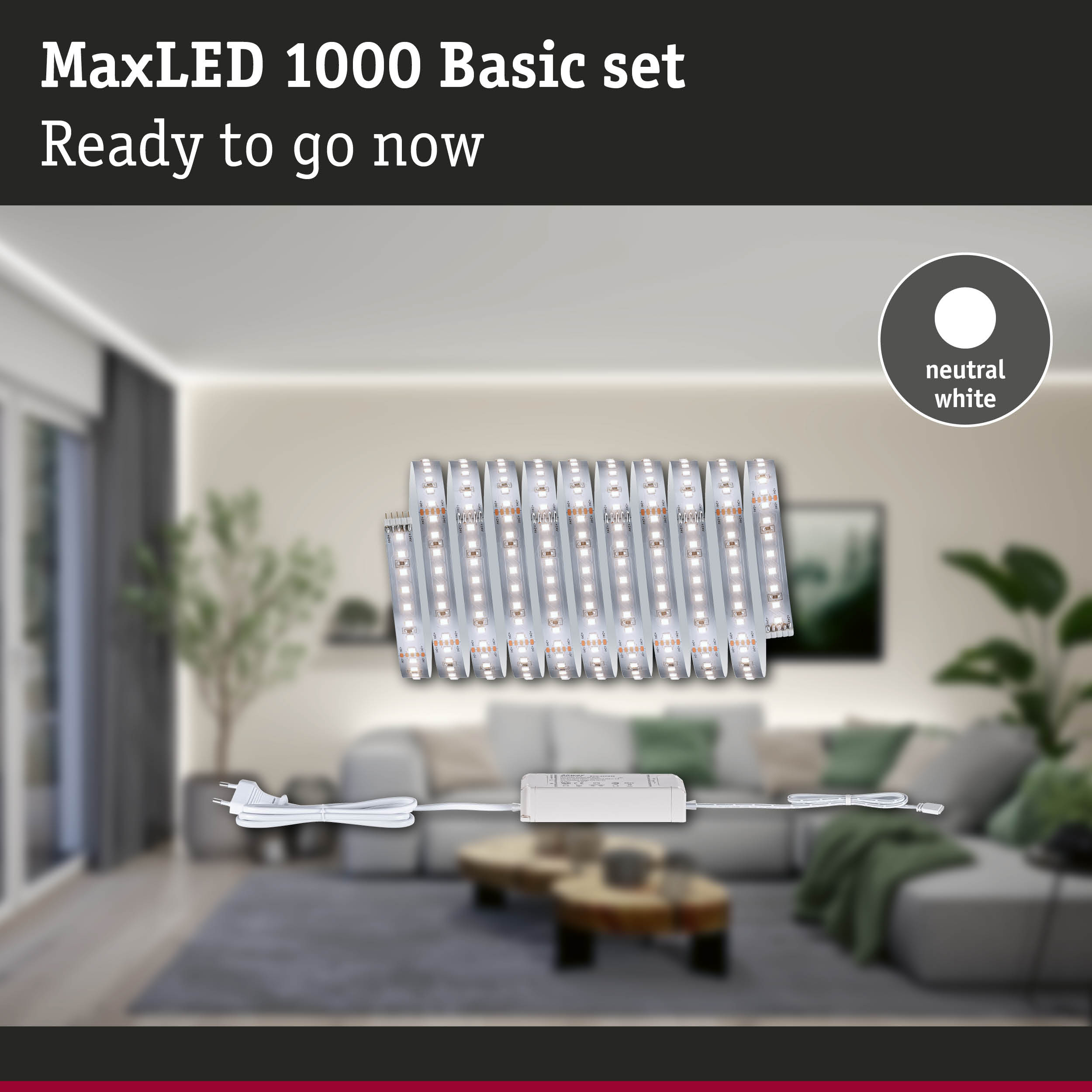 MaxLED 1000 Basisset mit neutralweißem Licht und Stromkabel vor einem Wohnzimmer.