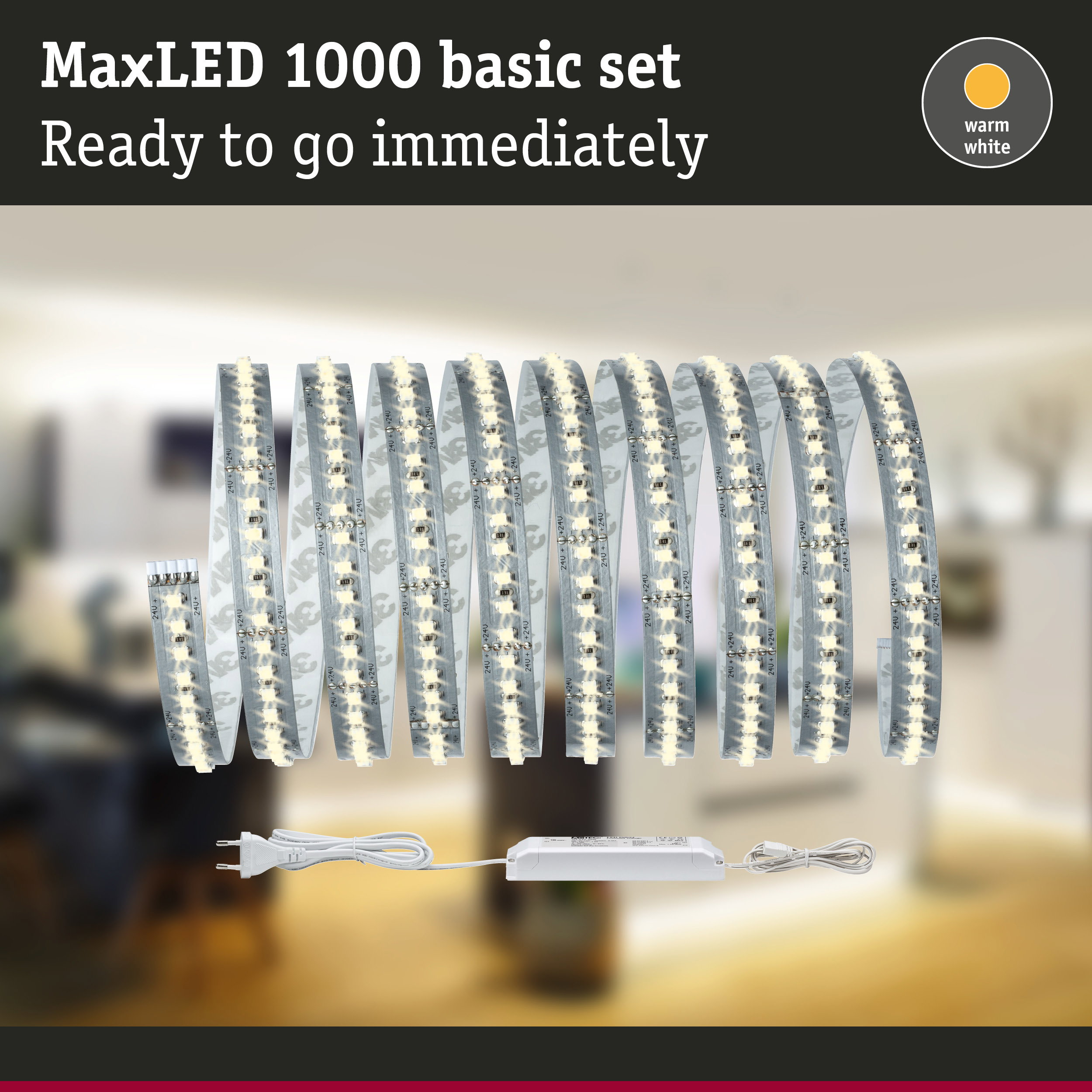 Produktwerbung für das MaxLED 1000 Basic Set mit warmweißem Licht, LED-Streifen und Netzteil vor verschwommenem Hintergrund.