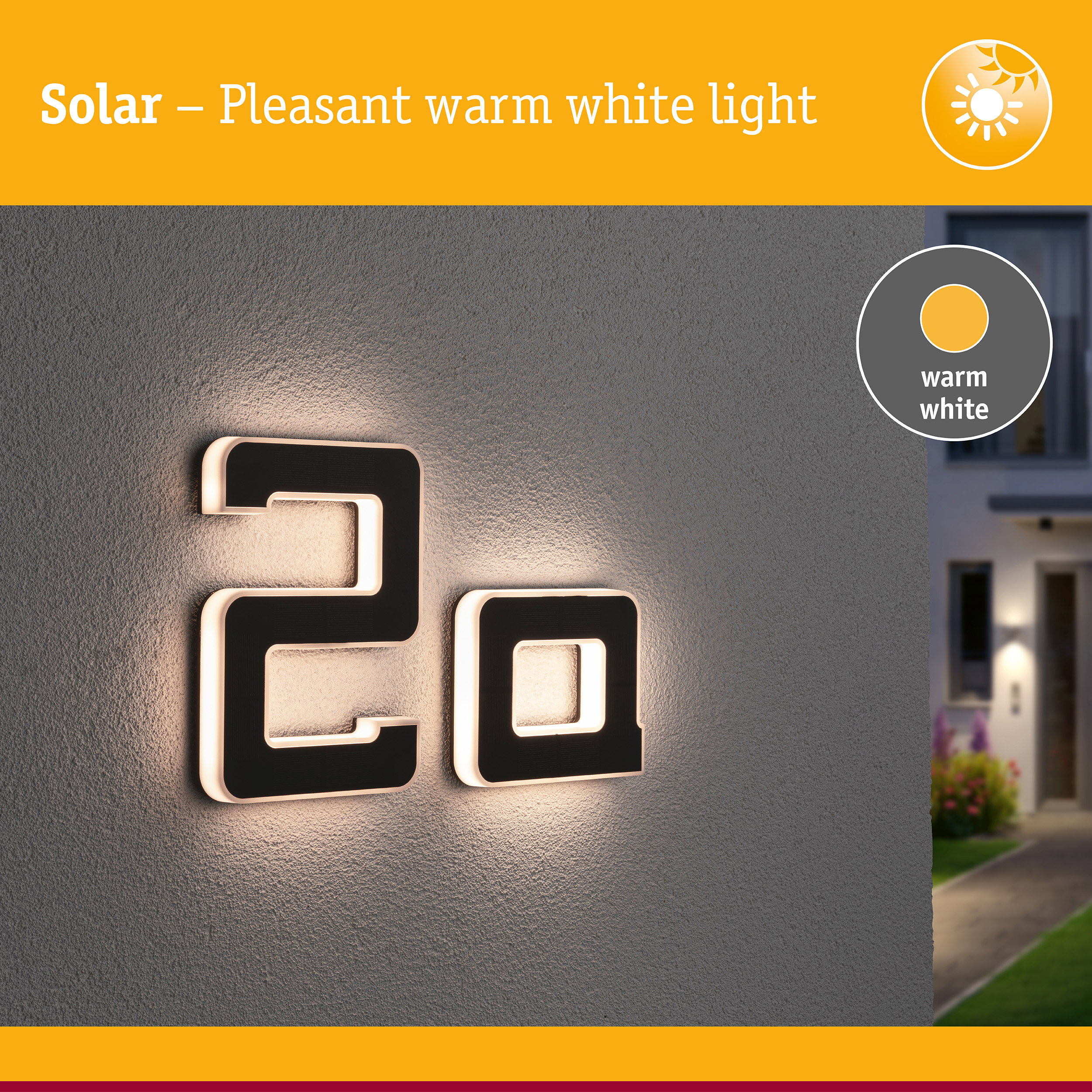 Solar-Hausnummer 2a leuchtet warmweiß an einer grauen Wand.