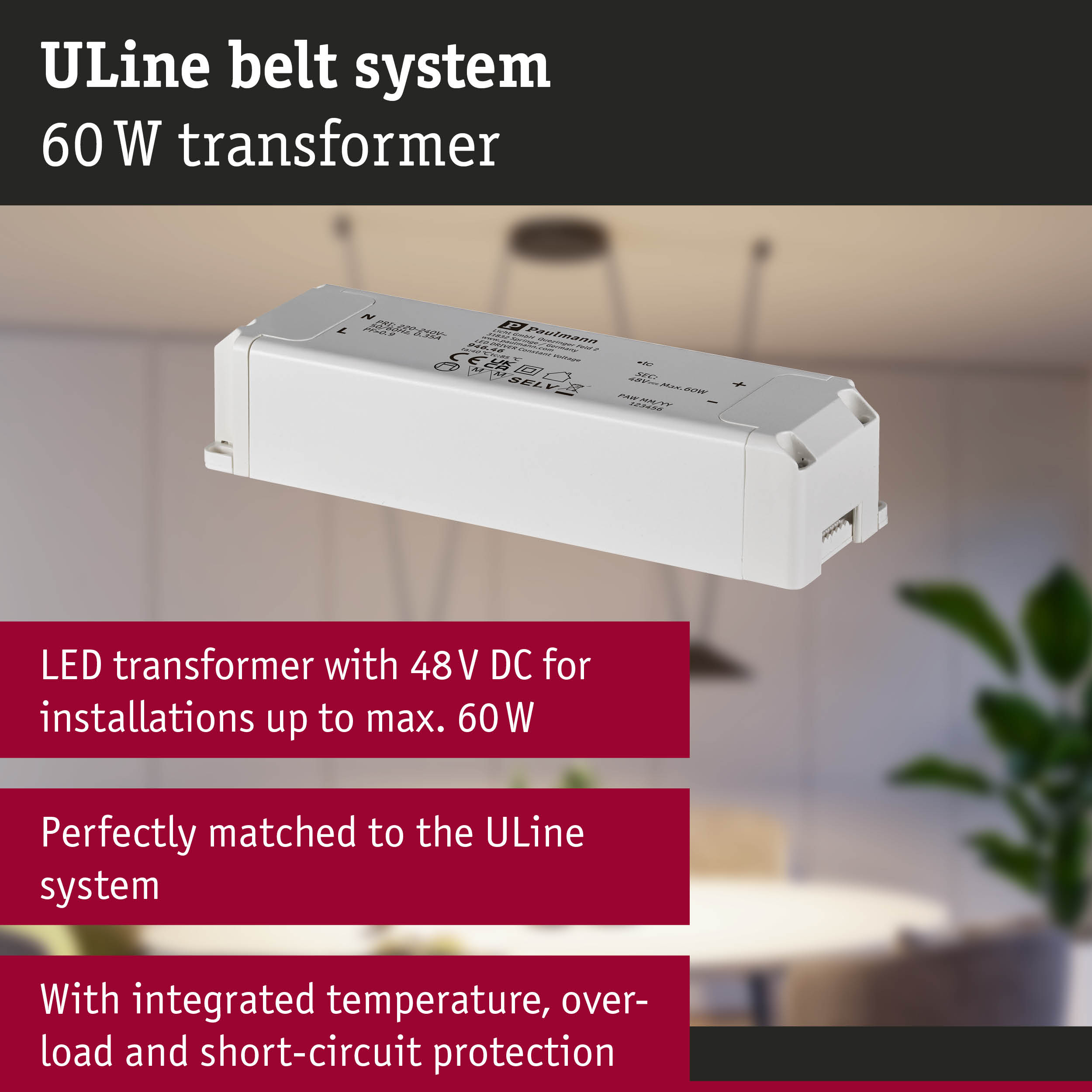 Biały transformator LED ULine 60W z 48V DC na rozmytym tle wnętrza z czerwonymi polami teksty.