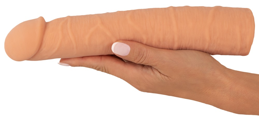 Eine Hand hält eine fleischfarbene, realistische Dildo-Nachbildung auf weißem Hintergrund.