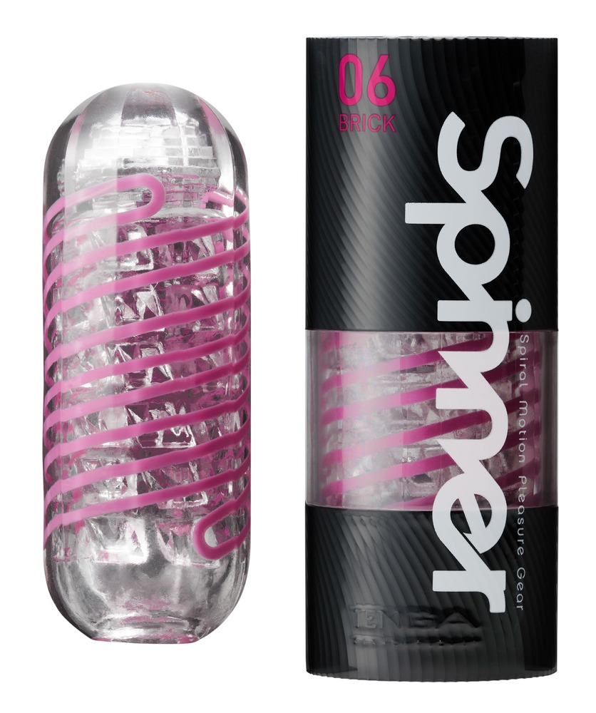 Ein durchsichtiges Wellnessprodukt mit rosa Spirale daneben eine schwarze Verpackung mit Aufschrift Spinner 06 Brick.