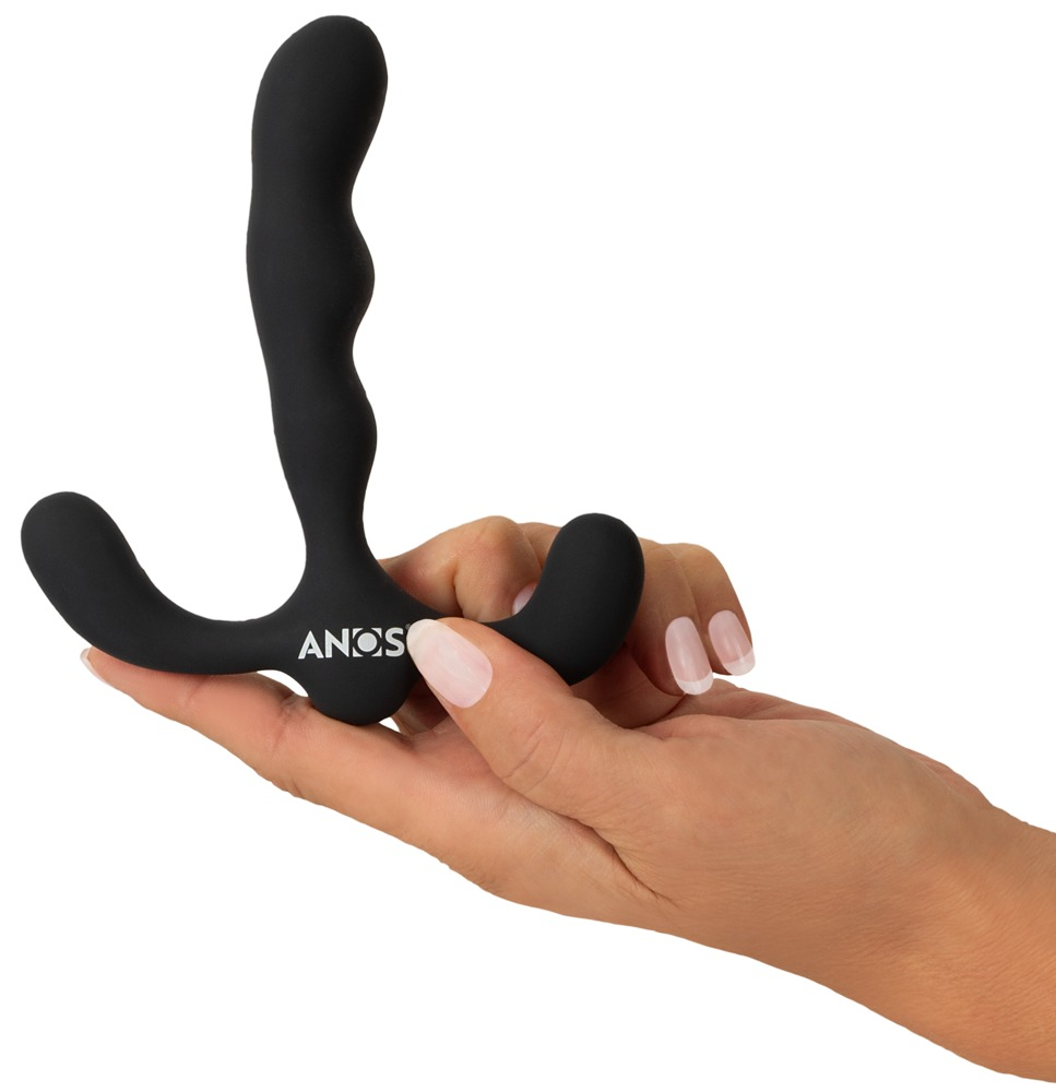 Eine Hand hält ein schwarzes, wellenförmiges Wellness-Silikonprodukt auf weißem Hintergrund.