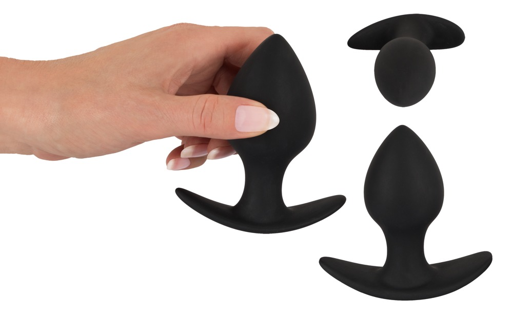Hand hält einen schwarzen Silikon-Analplug mit Ständer.