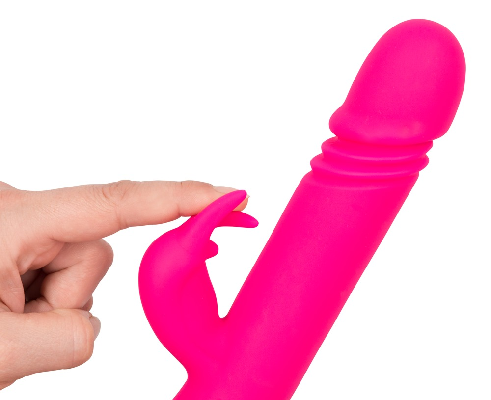 Ein Finger berührt den Hasenohren-Aufsatz eines leuchtend rosa Silikonvibrators vor weißem Hintergrund.