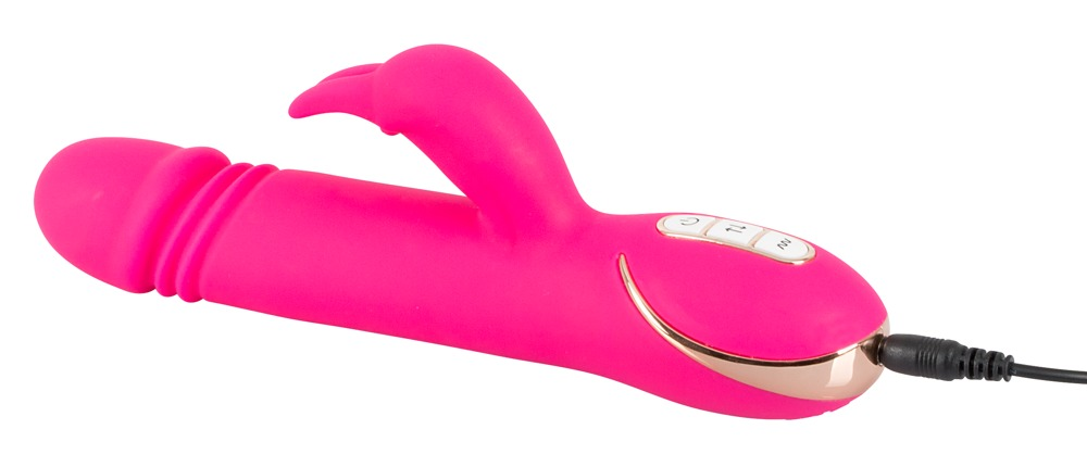 Ein pinkfarbener, kabelloser Vibrator mit Kontrolltasten und Ladekabel auf weißem Hintergrund.