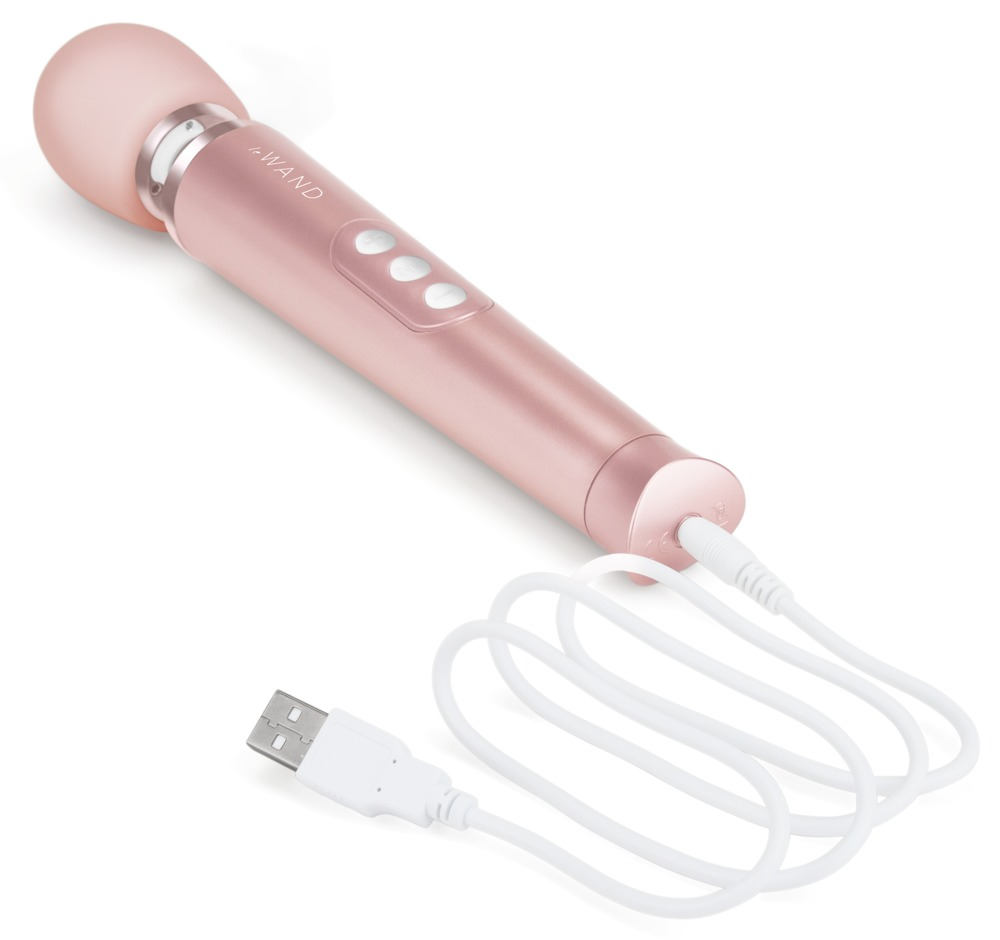 Ein roségoldener kabelloser Stabmassager mit Bedientasten, verbunden mit einem weißen Ladekabel und USB-Stecker.