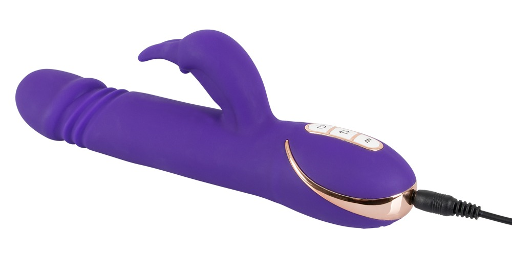 Ein lila Silikonvibrator mit einem gebogenen Arm und Roségold-Akzenten, verbunden mit einem schwarzen Ladekabel.