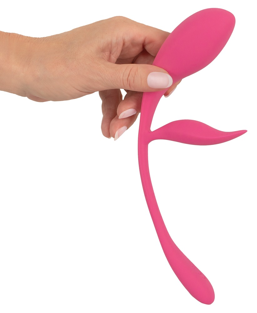 Eine Hand hält einen pinken, blütenförmigen Massage-Dildo auf weißem Hintergrund.