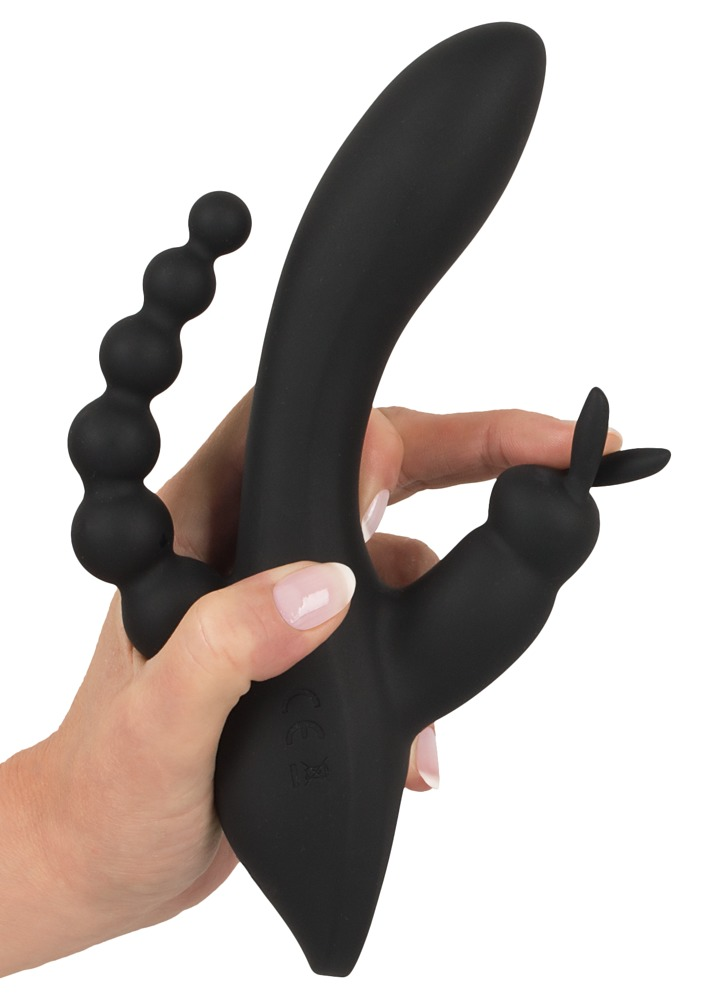 Hand hält ein schwarzes, mehrteiliges Sexspielzeug aus Silikon vor weißem Hintergrund.