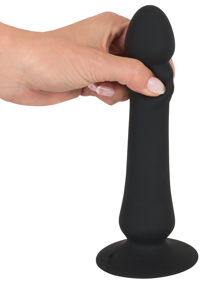 Eine Hand hält ein schwarzes, phallisches Sexspielzeug mit Saugnapf.
