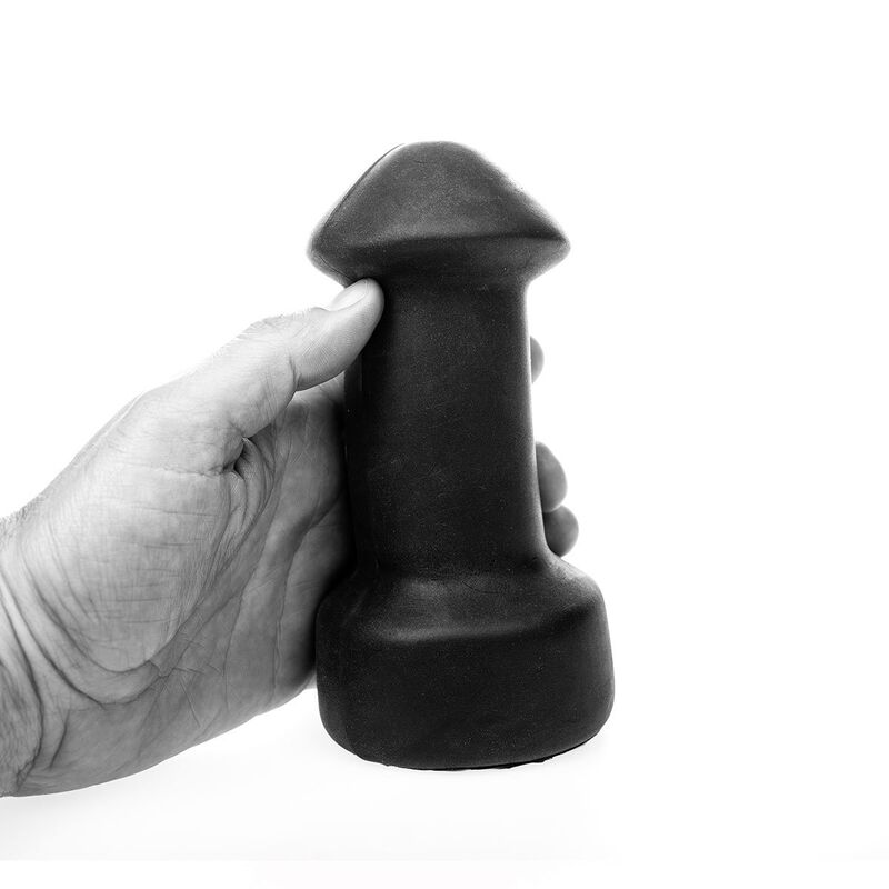 Eine Hand hält einen schwarzen, pilzförmigen Gegenstand vor weißem Hintergrund.