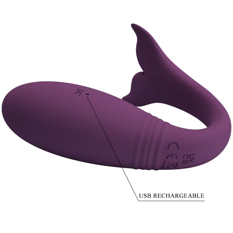 Un masajeador de silicona morado con forma de ballena y cola, con marcas y la etiqueta USB RECHARGEABLE.