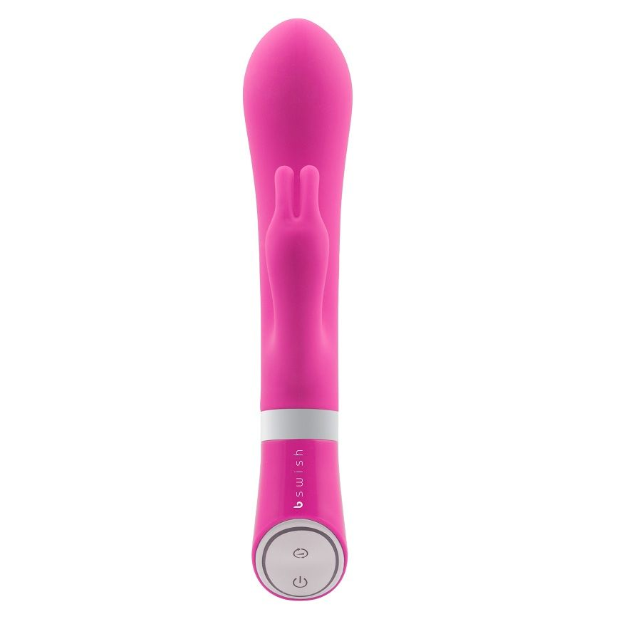 Un vibrador para adultos rosa con base blanca y un botón de control plateado sobre fondo blanco.